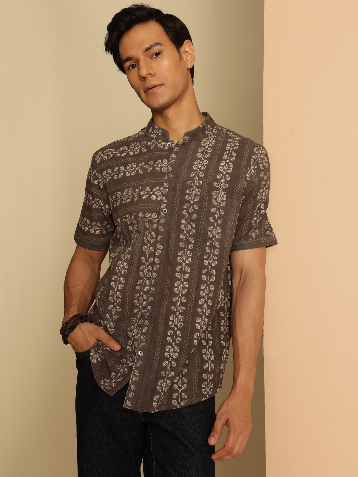 Angled view of grey cotton Dabu block printed shirt highlighting print and fabric texture.