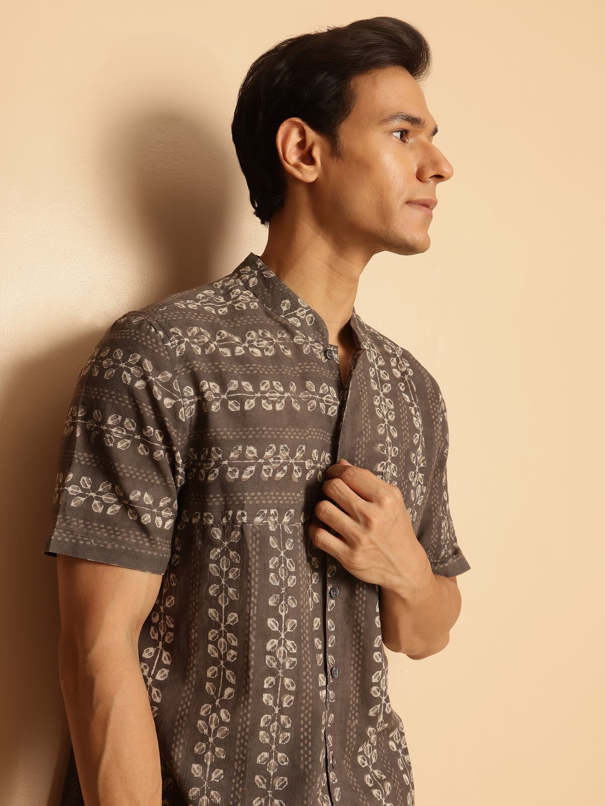 Detailed close-up of block print and cotton weave on grey shirt.