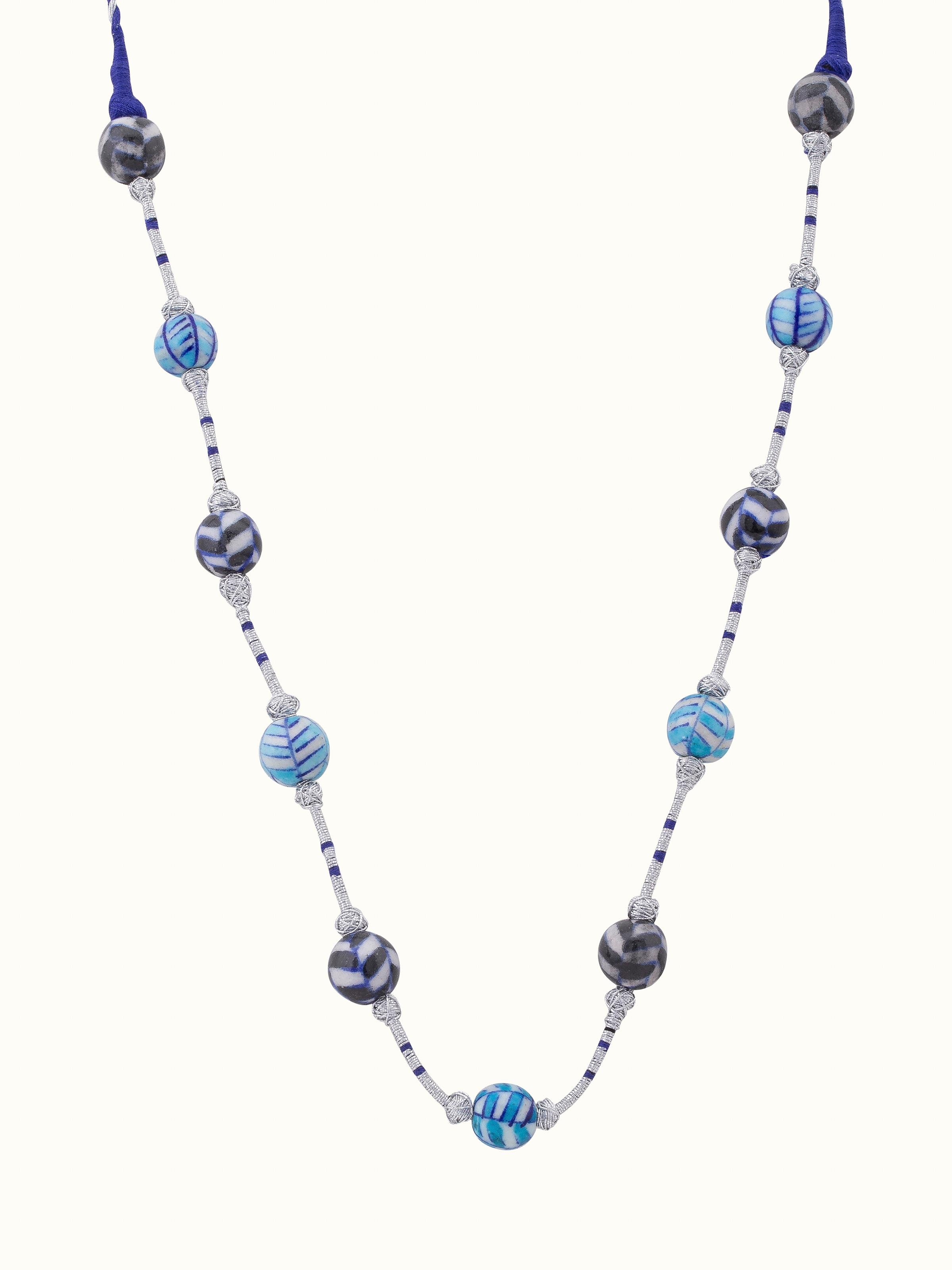 Front view of blue pottery long necklace featuring vibrant blue pottery and intricate design.
