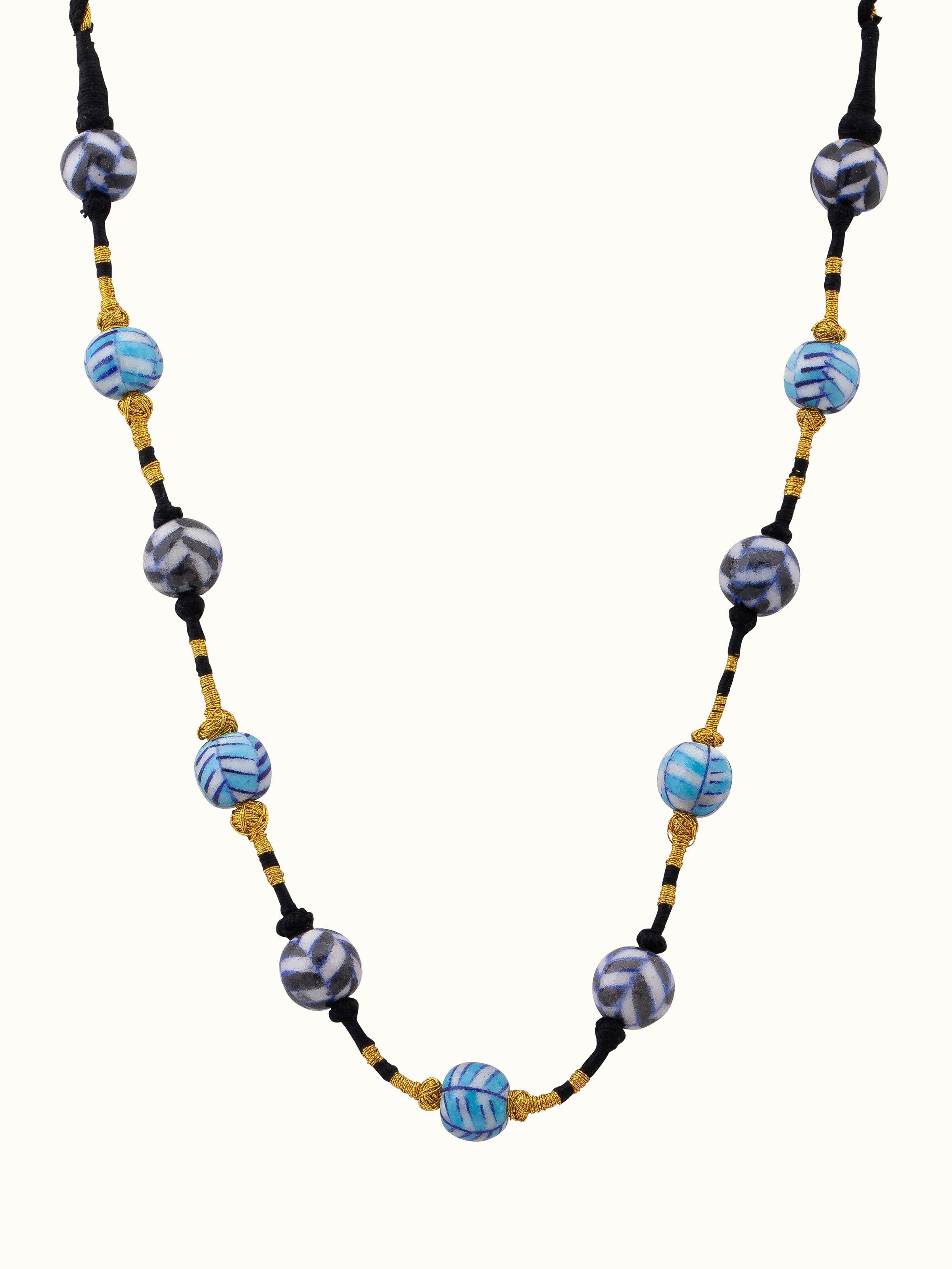 Front view of blue pottery long necklace featuring natural blue pottery stones and elegant design.