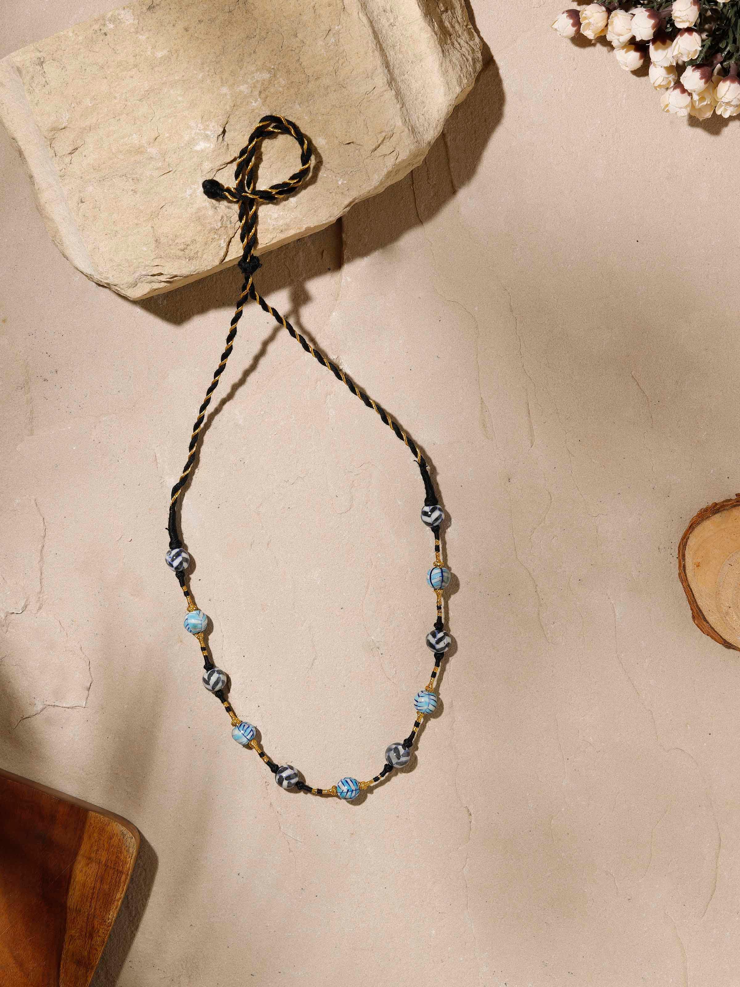 Close-up view of blue pottery long necklace showcasing the detailed stone arrangement.
