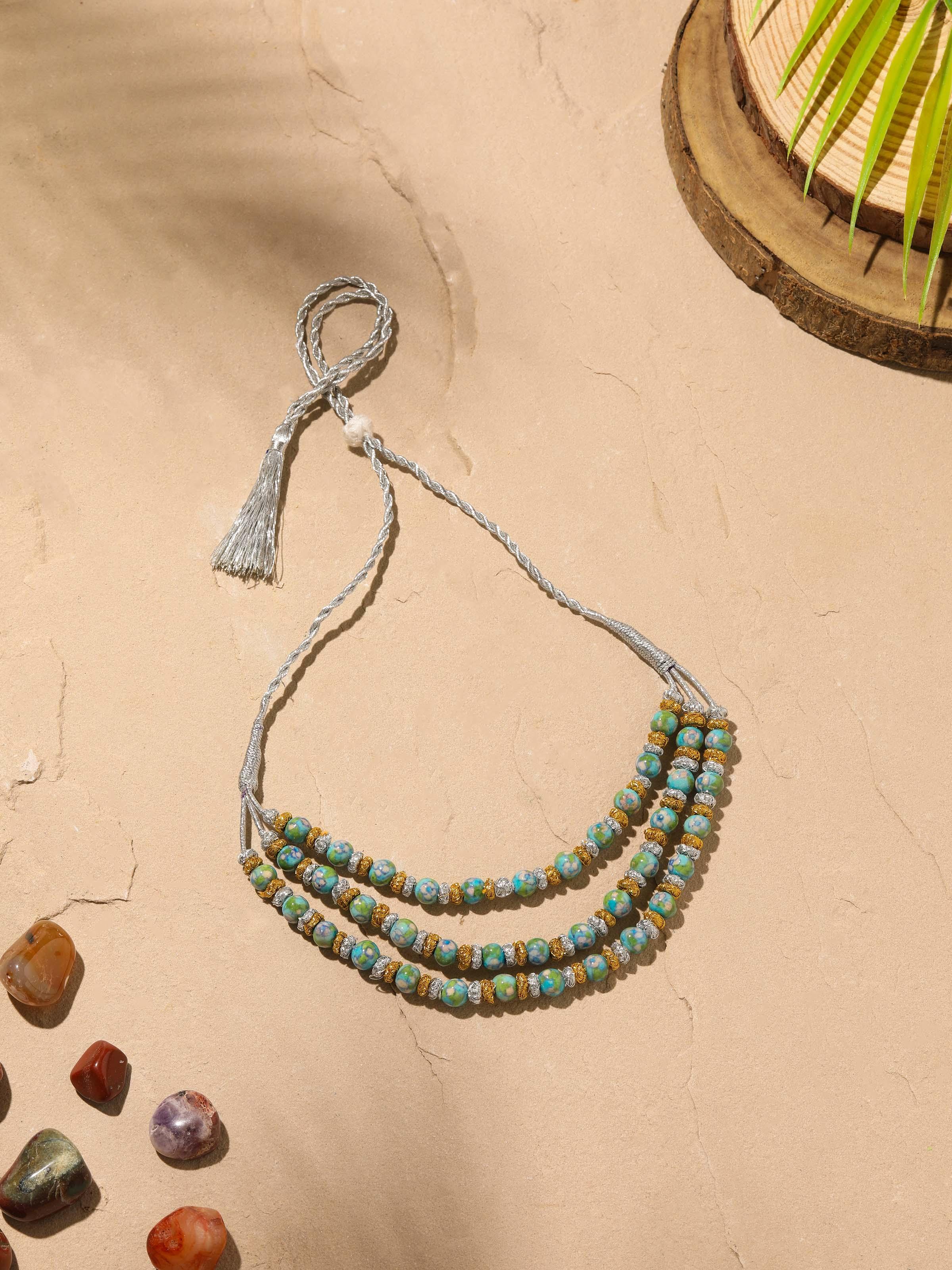 Angled view of Blue Pottery Long Necklace showcasing detailed blue pottery design and craftsmanship.