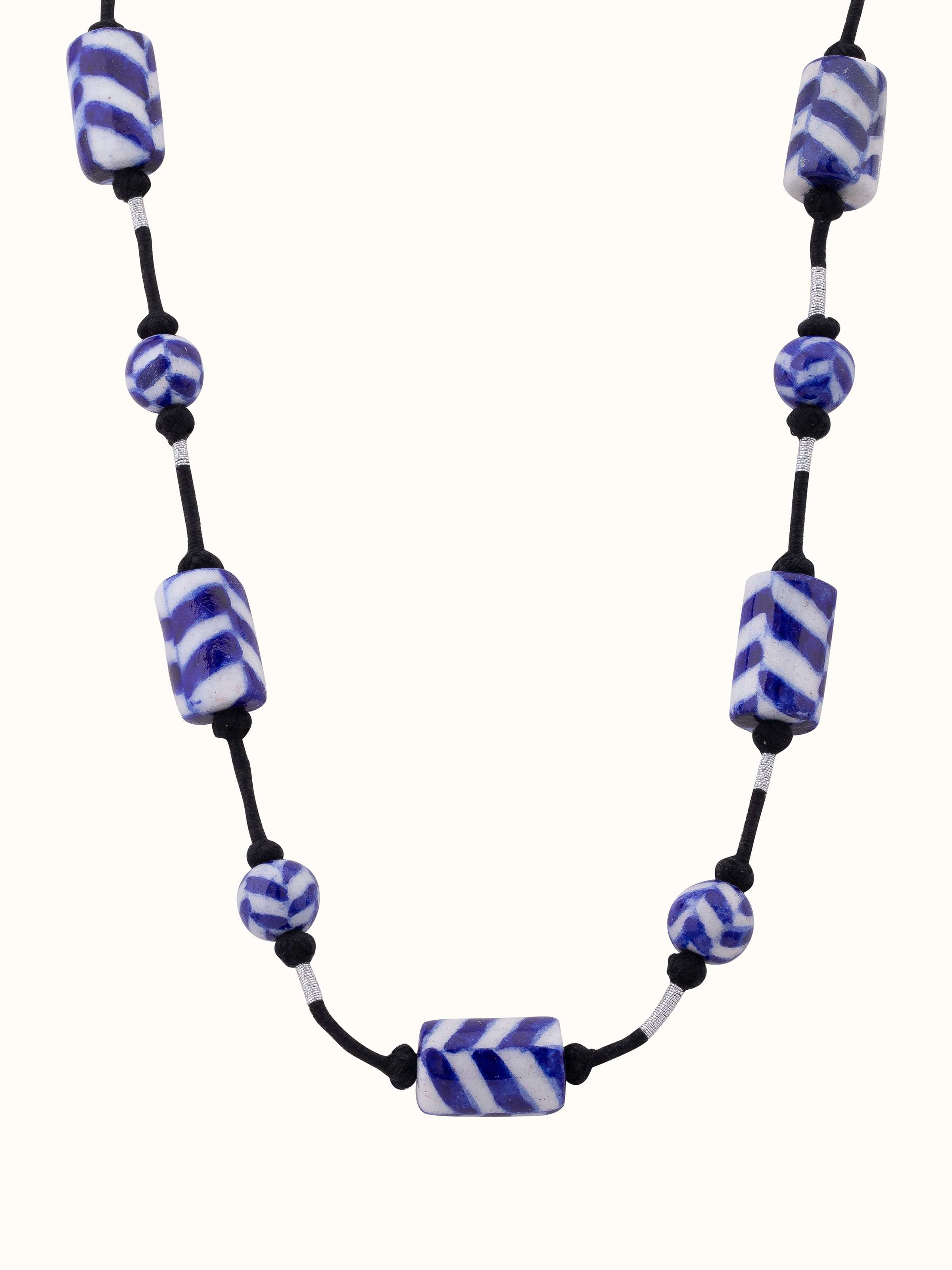 Front view of blue pottery long necklace featuring intricate pottery designs and vibrant blue colors.