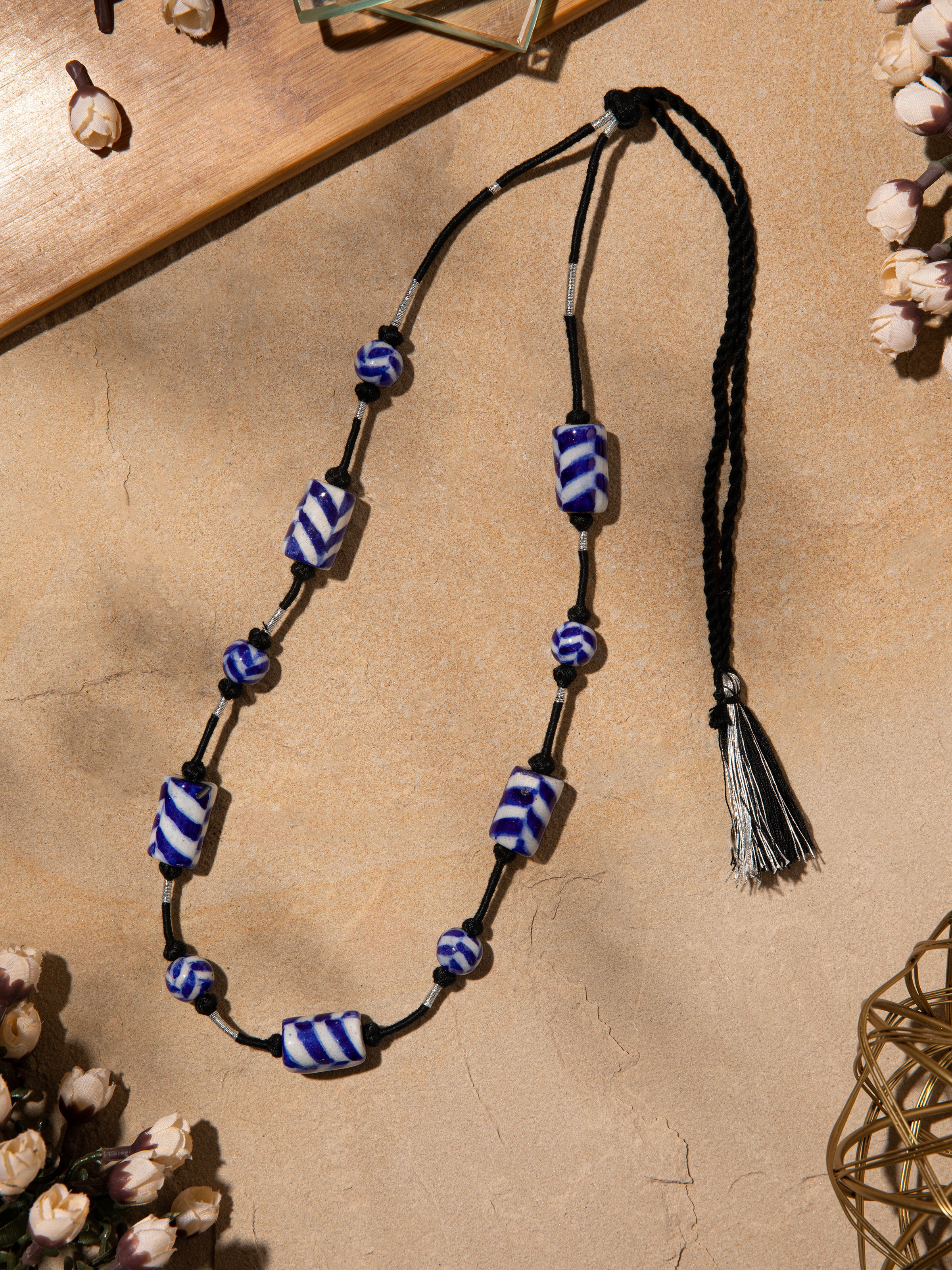 Close-up view of blue pottery long necklace highlighting the craftsmanship and intricate designs.