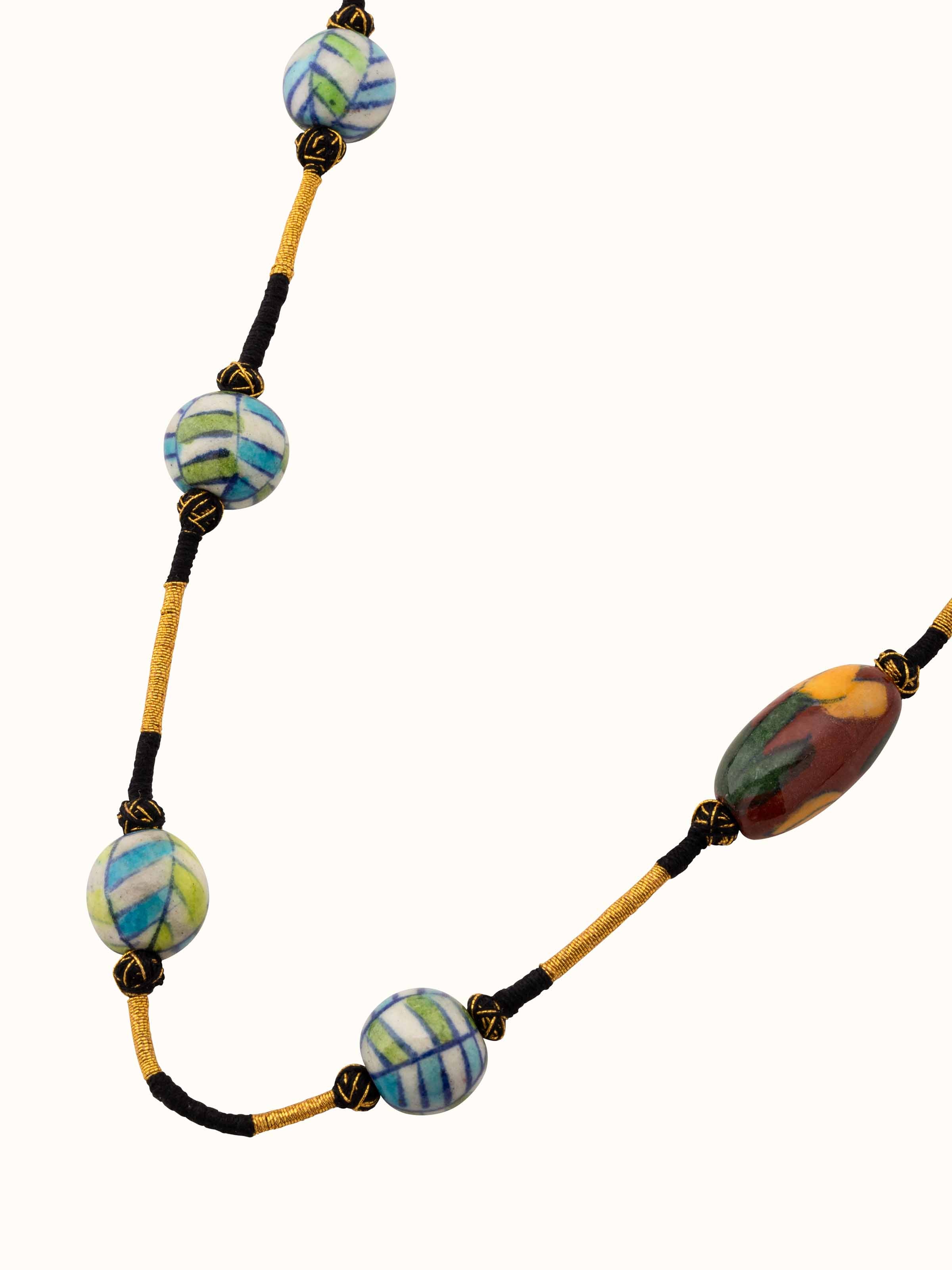 Angled view of Blue Pottery Long Necklace showcasing its vibrant colors and elegant design.