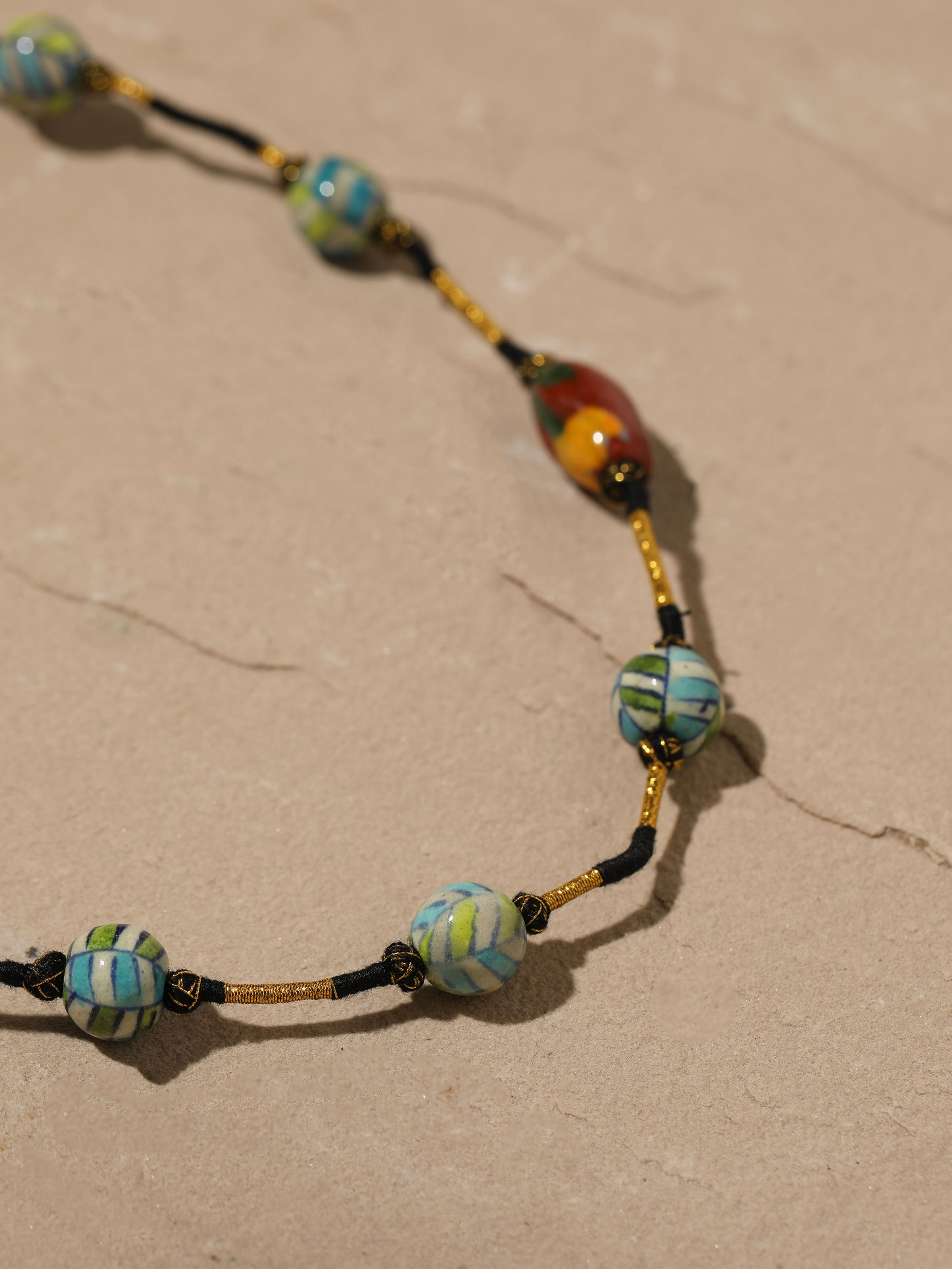 Detailed view of Blue Pottery Long Necklace from a distance, displaying the full length and design intricacies.