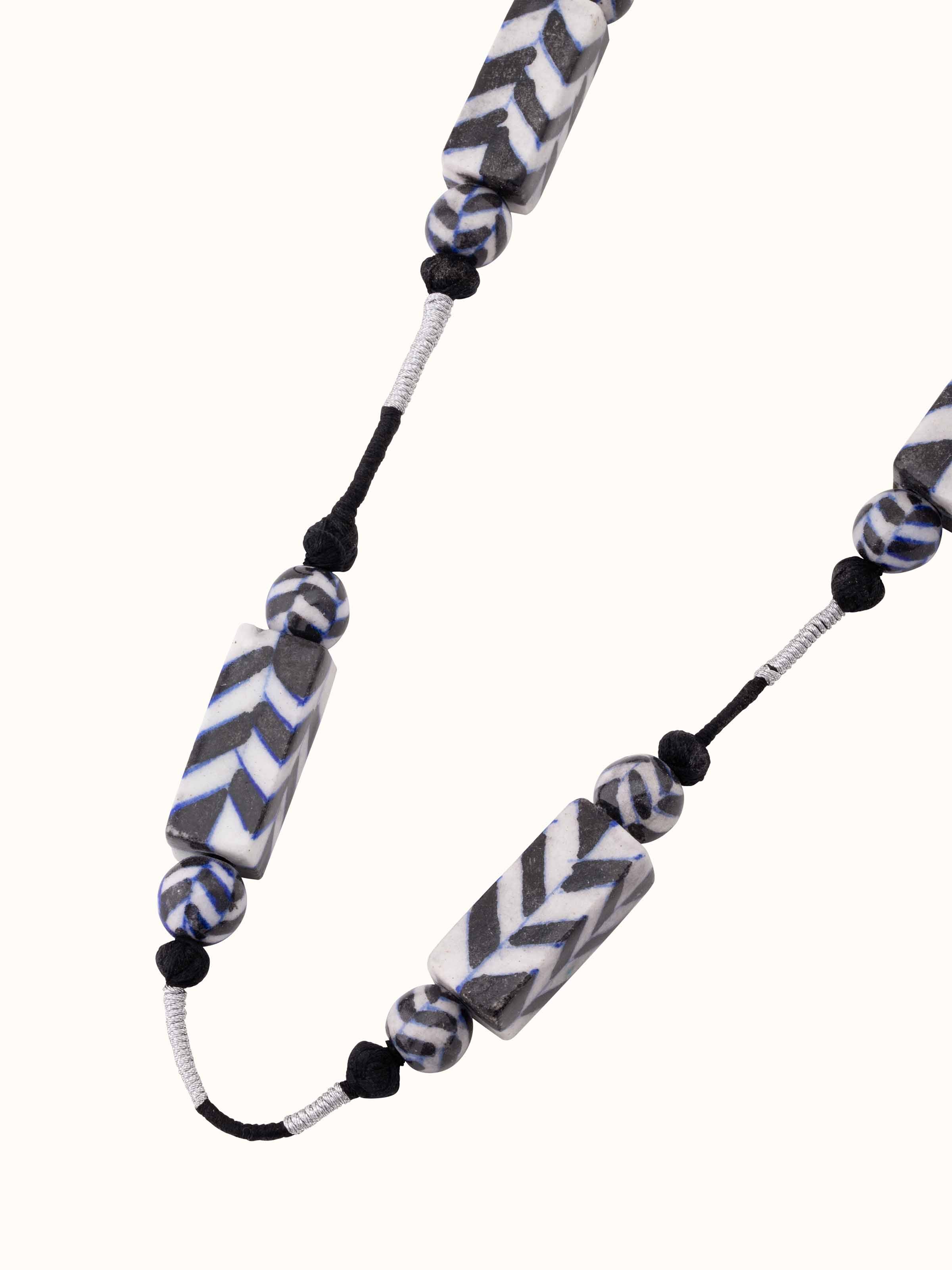 Overhead view of Blue Pottery Long Necklace showcasing the complete arrangement of blue pottery beads and design.