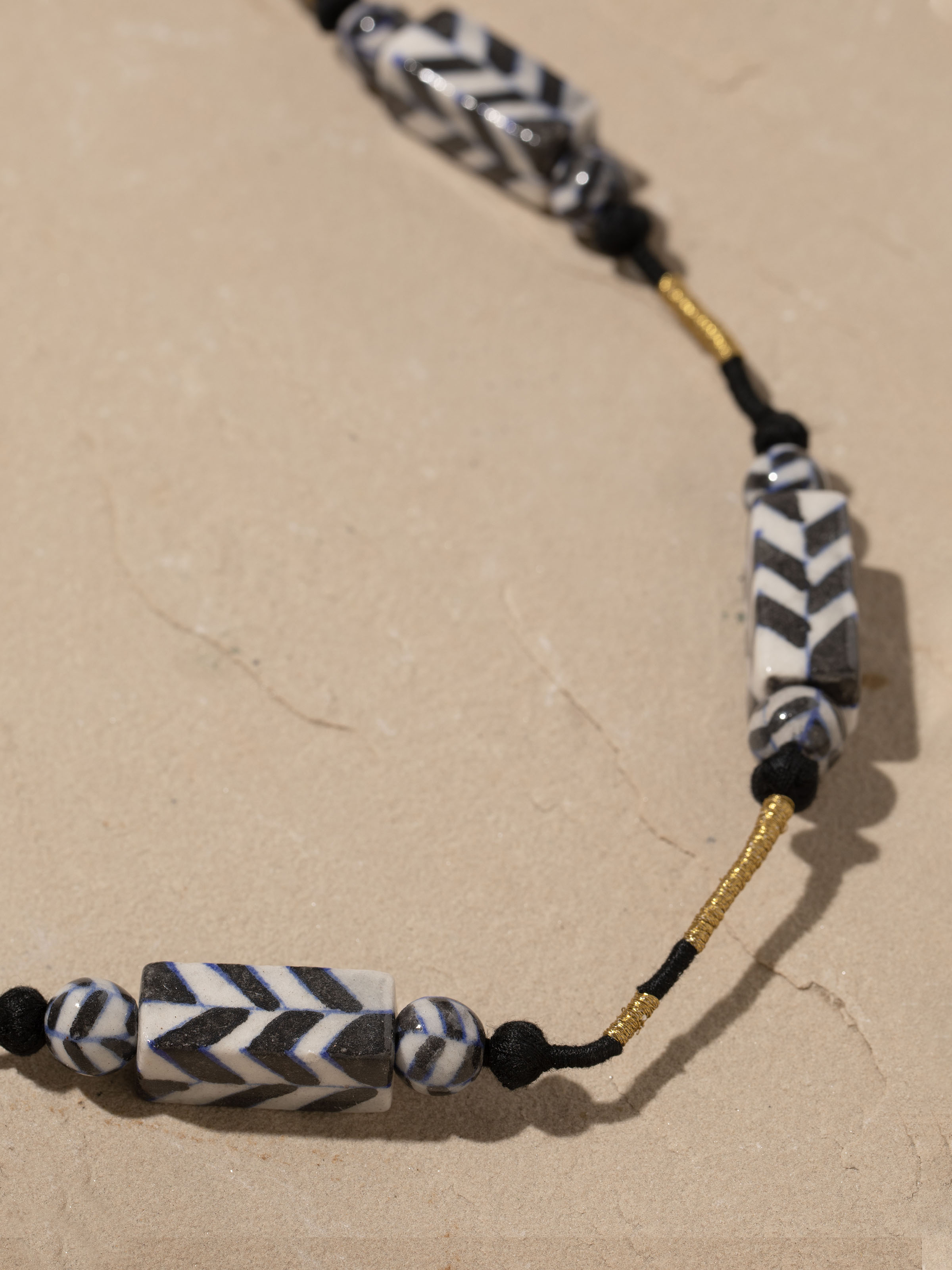 Detailed front view of Blue pottery long necklace highlighting its elegant design and vibrant blue ceramic