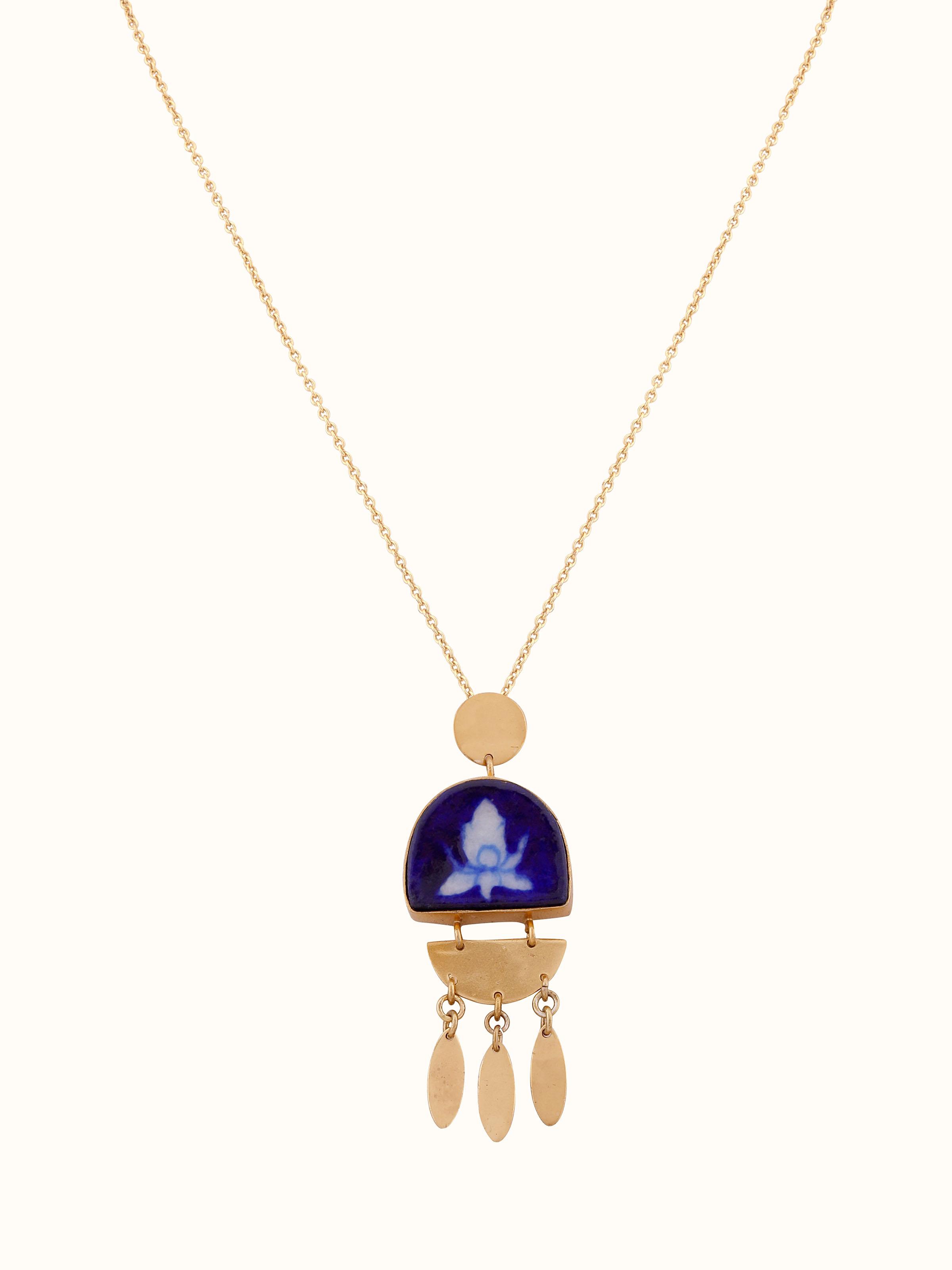 Front view of Blue pottery pendant and chain featuring intricate design and vibrant blue colors.