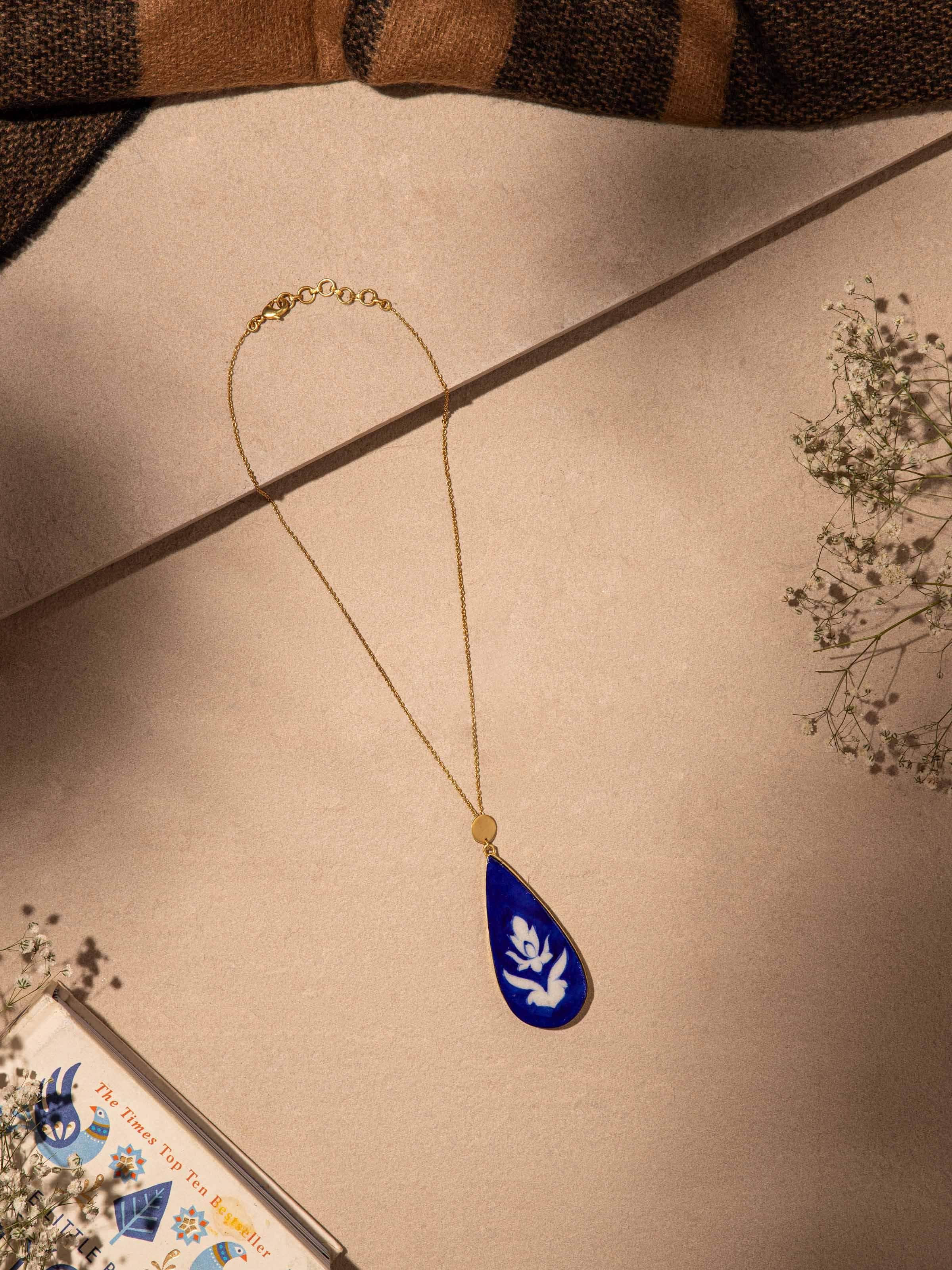 Close-up view of Blue Pottery Pendant & Chain featuring intricate blue pottery designs and fine chain detailing.