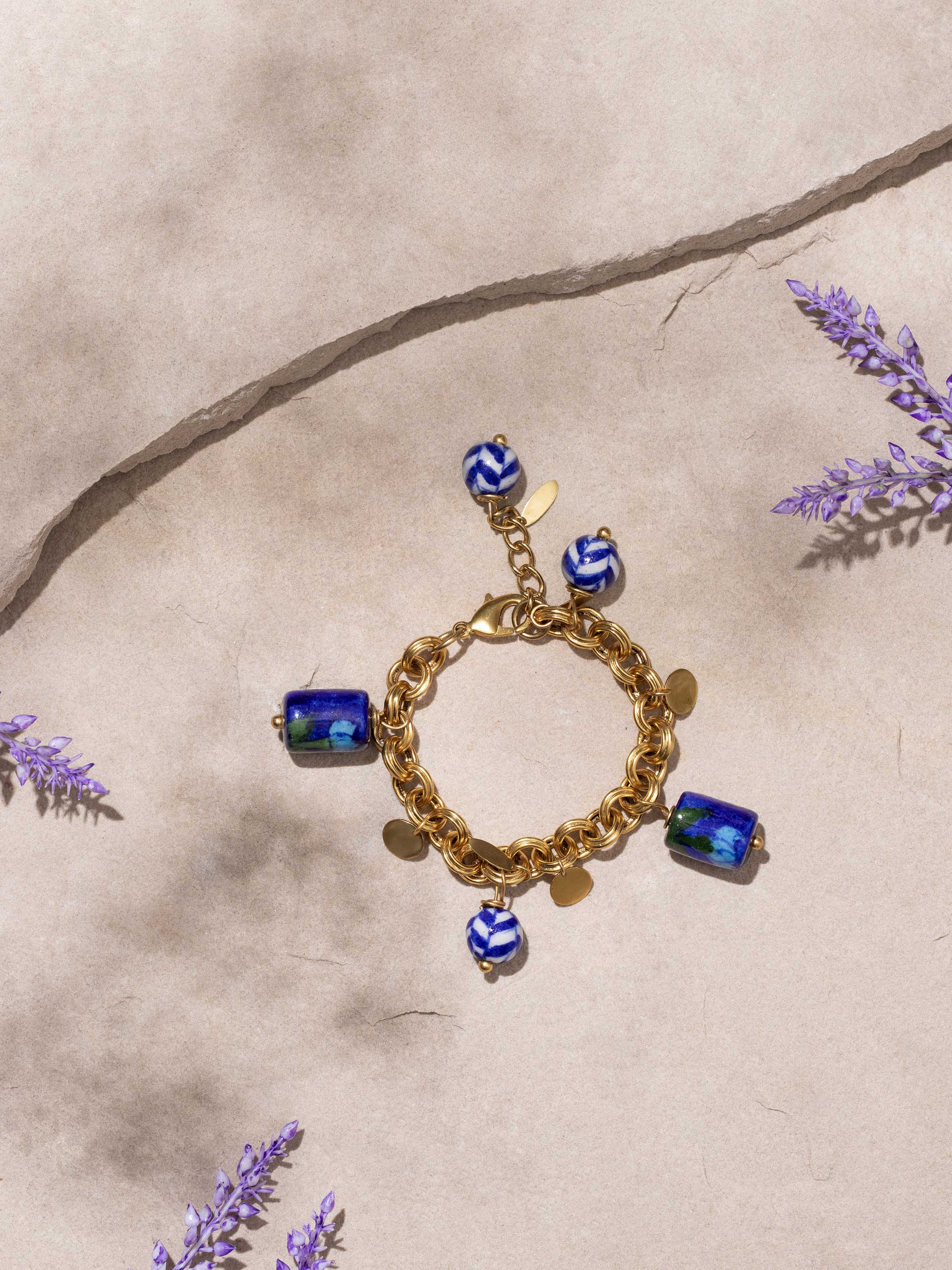 Side view of blue pottery pendant and chain highlighting the detailed craftsmanship