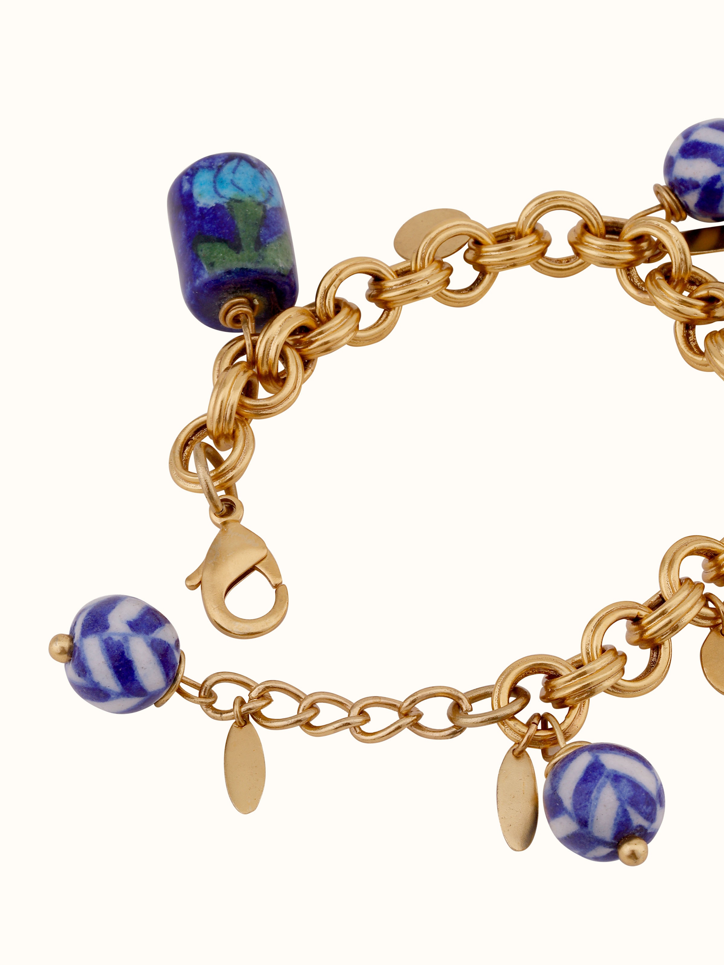 Detailed front view of blue pottery pendant and chain highlighting its unique blue glaze and finish