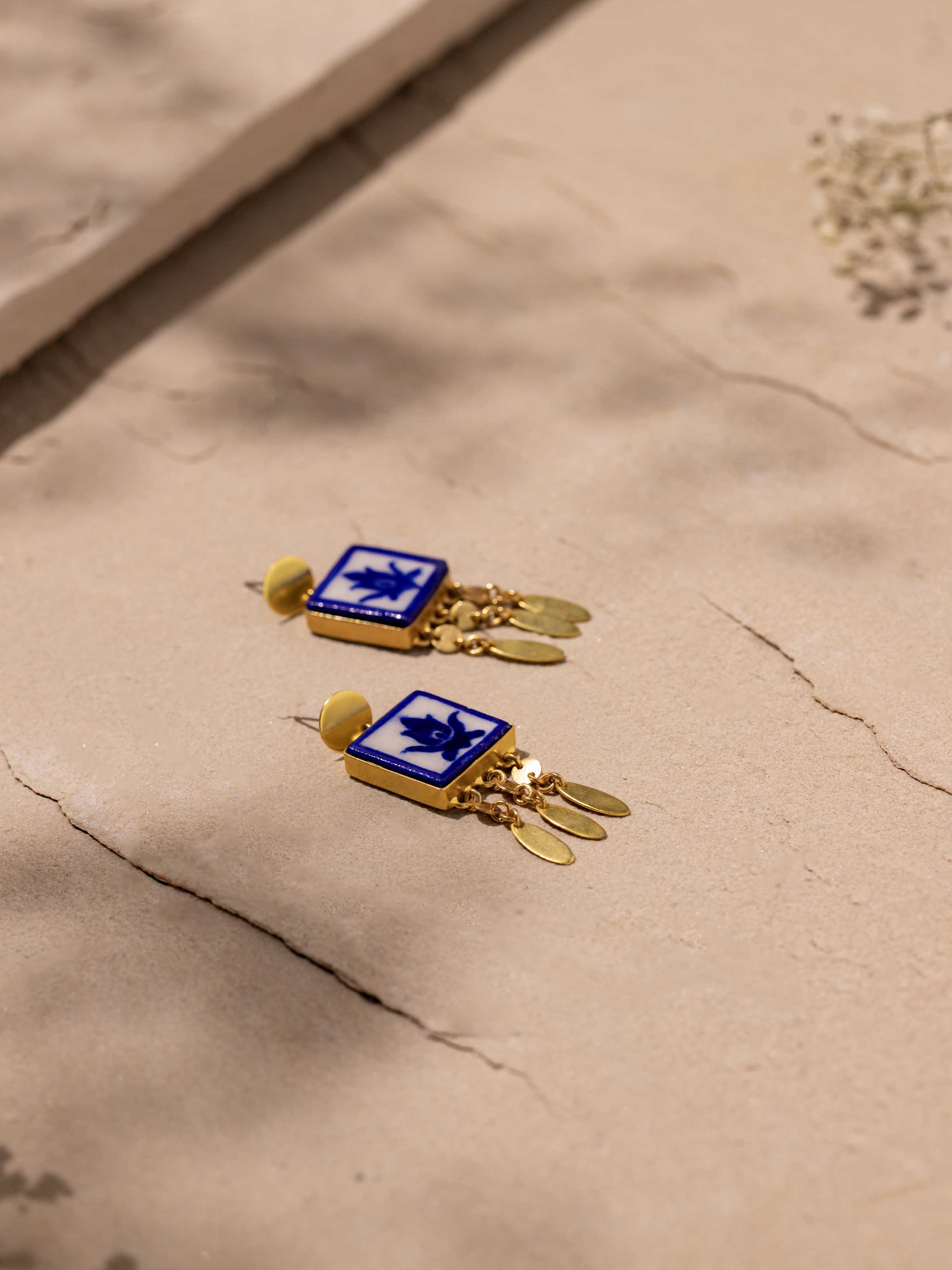 Detailed view of blue pottery drop earrings showing their unique glaze and finish.