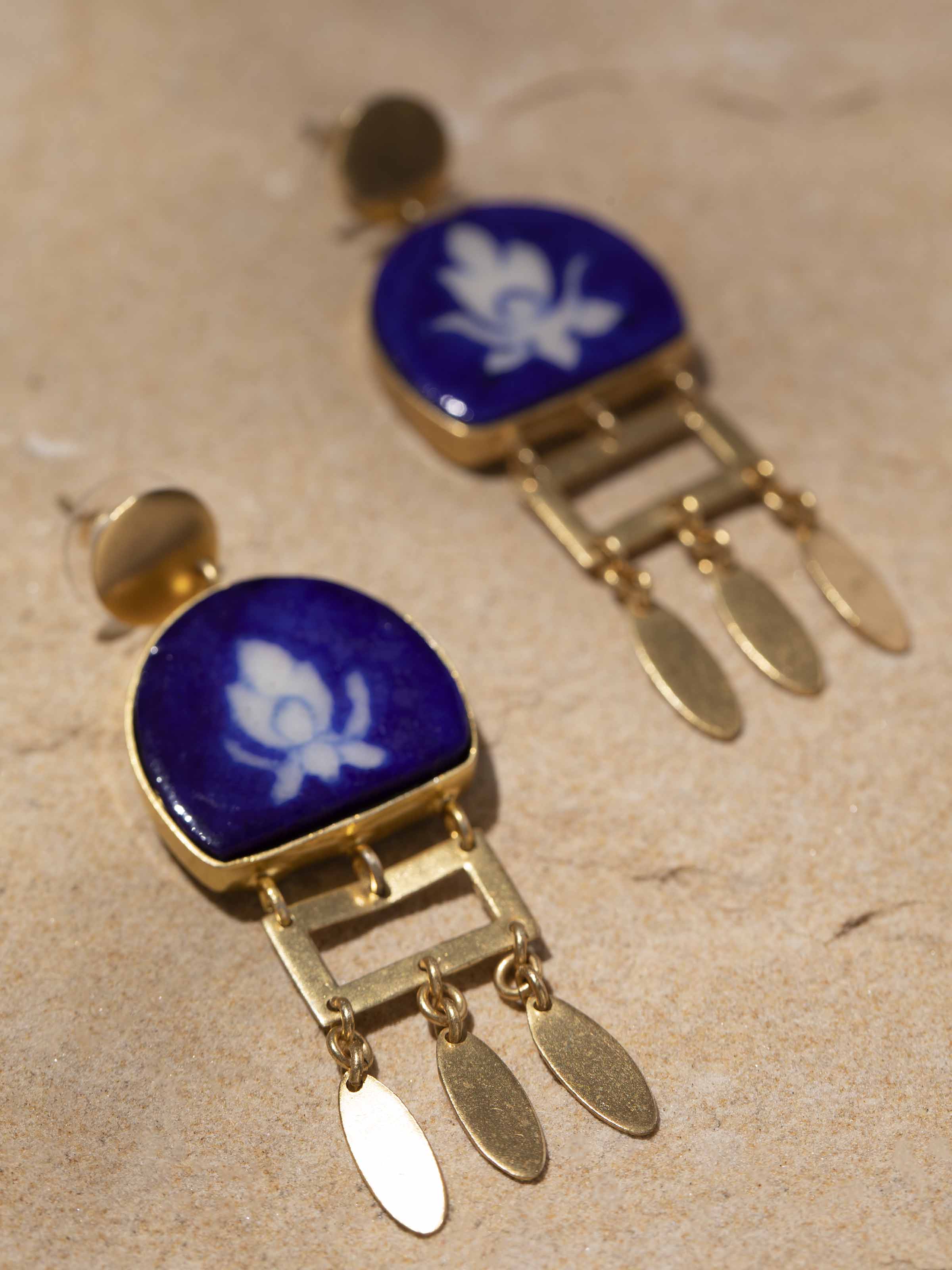 Detailed close-up of Blue Pottery Drop Earrings featuring intricate blue and white pattern.