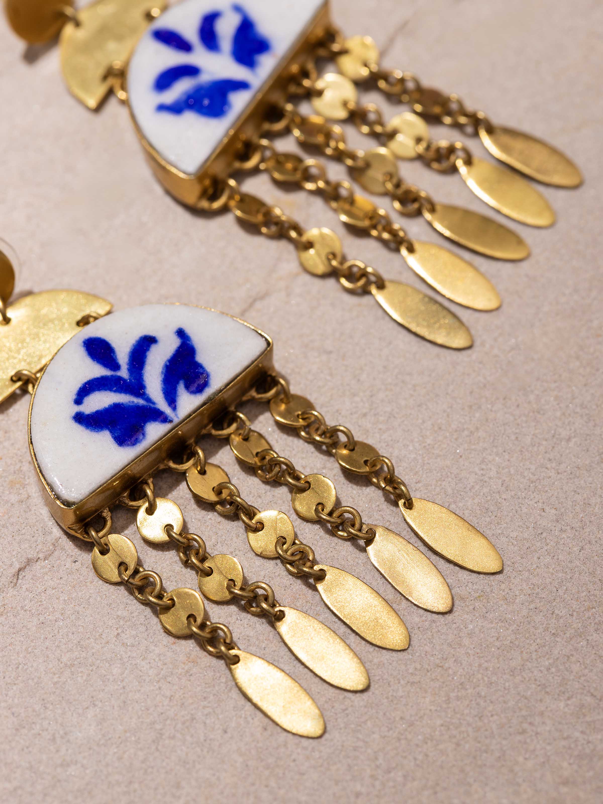 Angled view of Blue Pottery drop earrings showcasing unique design and detailed craftsmanship