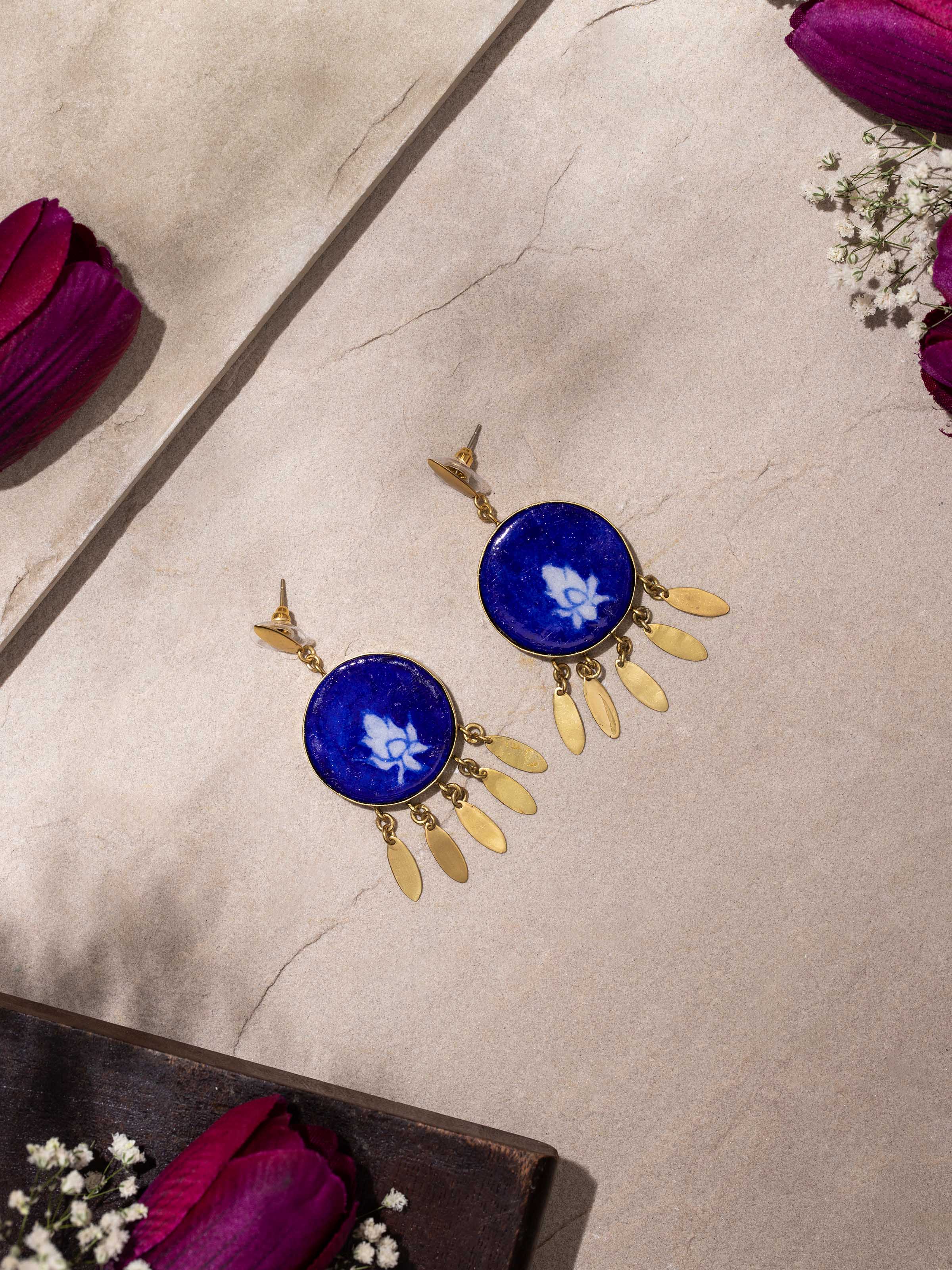 Close-up of Blue pottery drop earrings focusing on intricate ceramic detailing