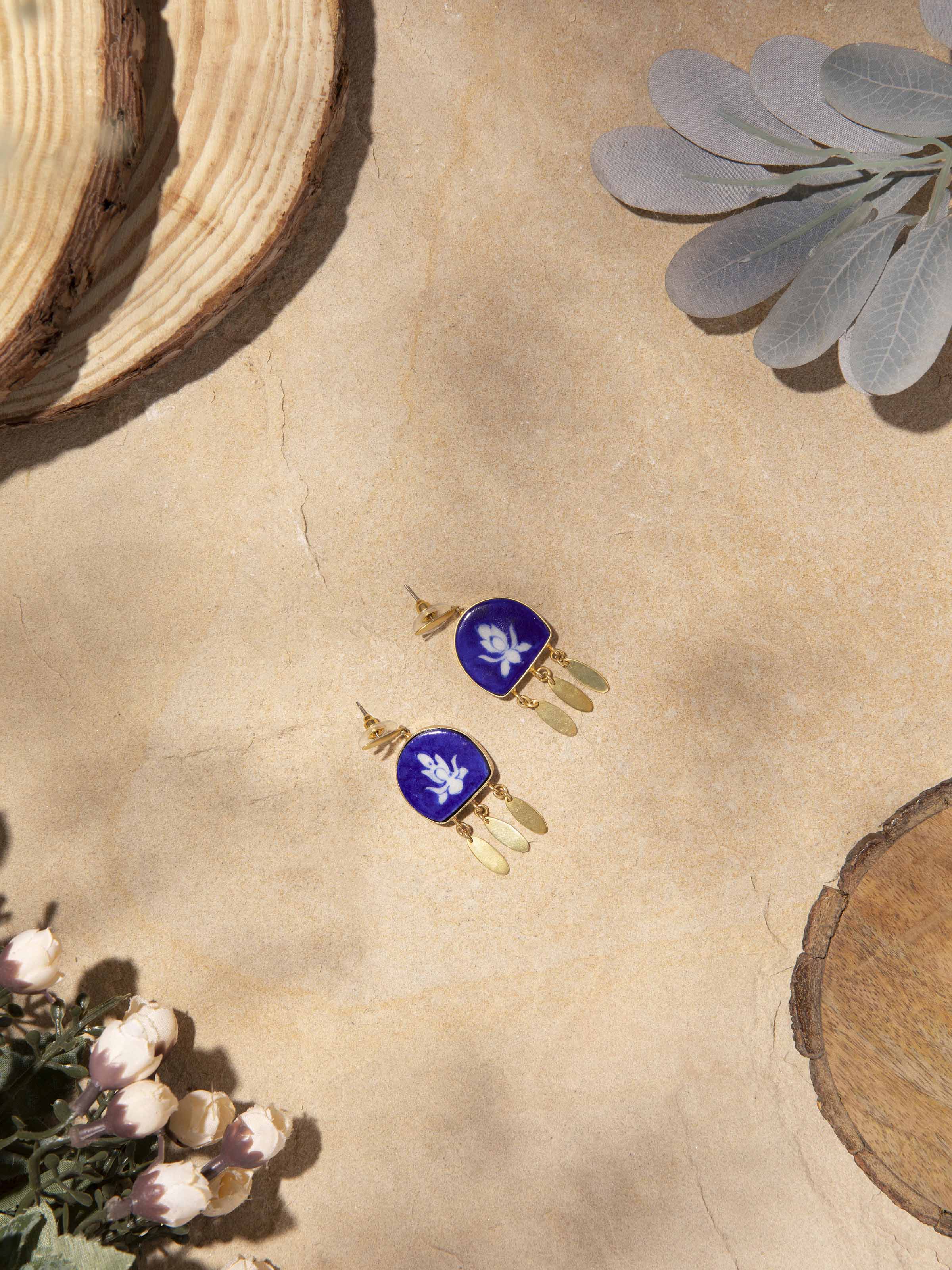 Side view of blue pottery drop earrings emphasizing their drop length and pottery design.