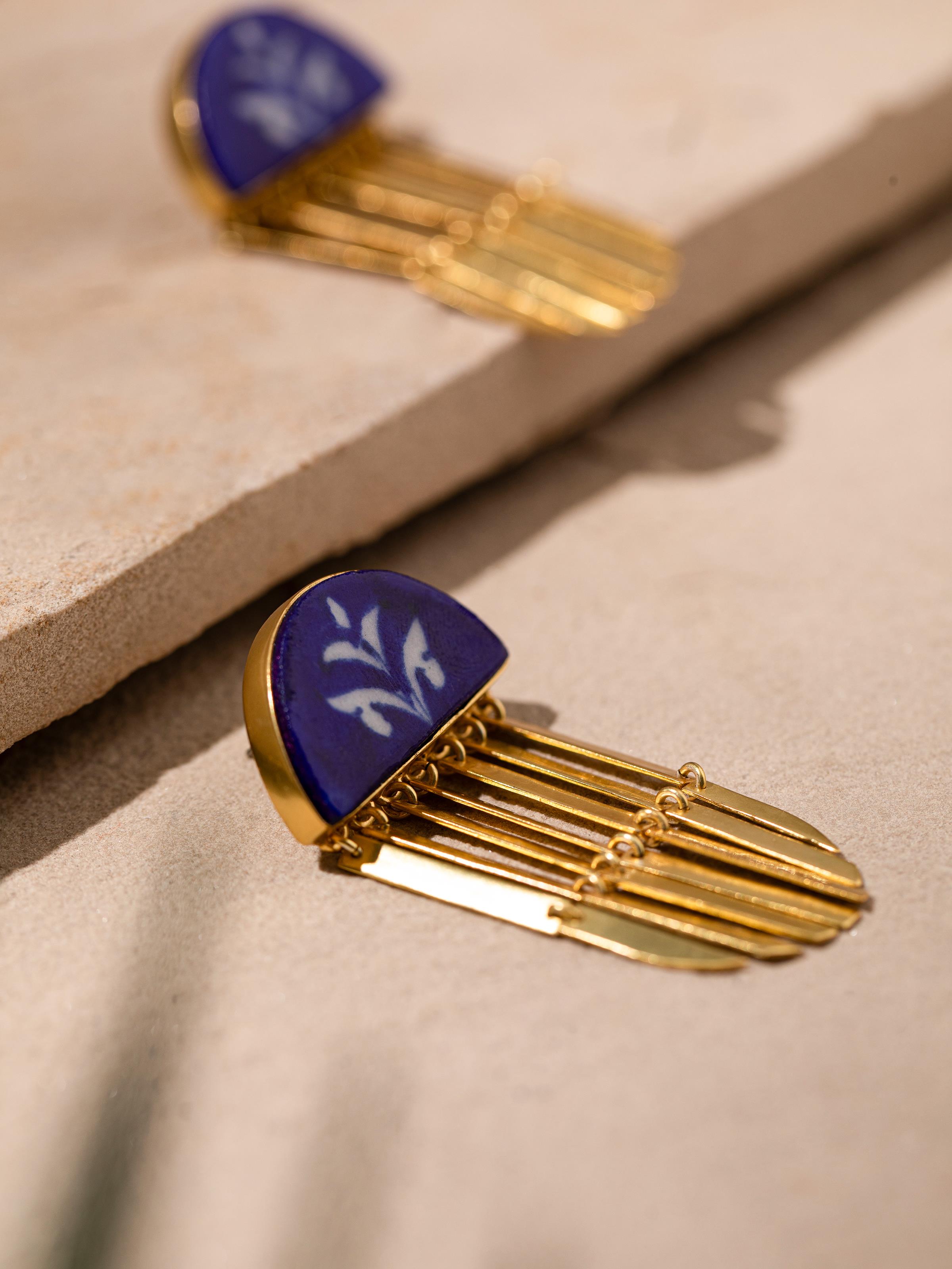 Overhead view of Blue Pottery Drop Earrings featuring the vibrant blue pottery and detailed drop design.