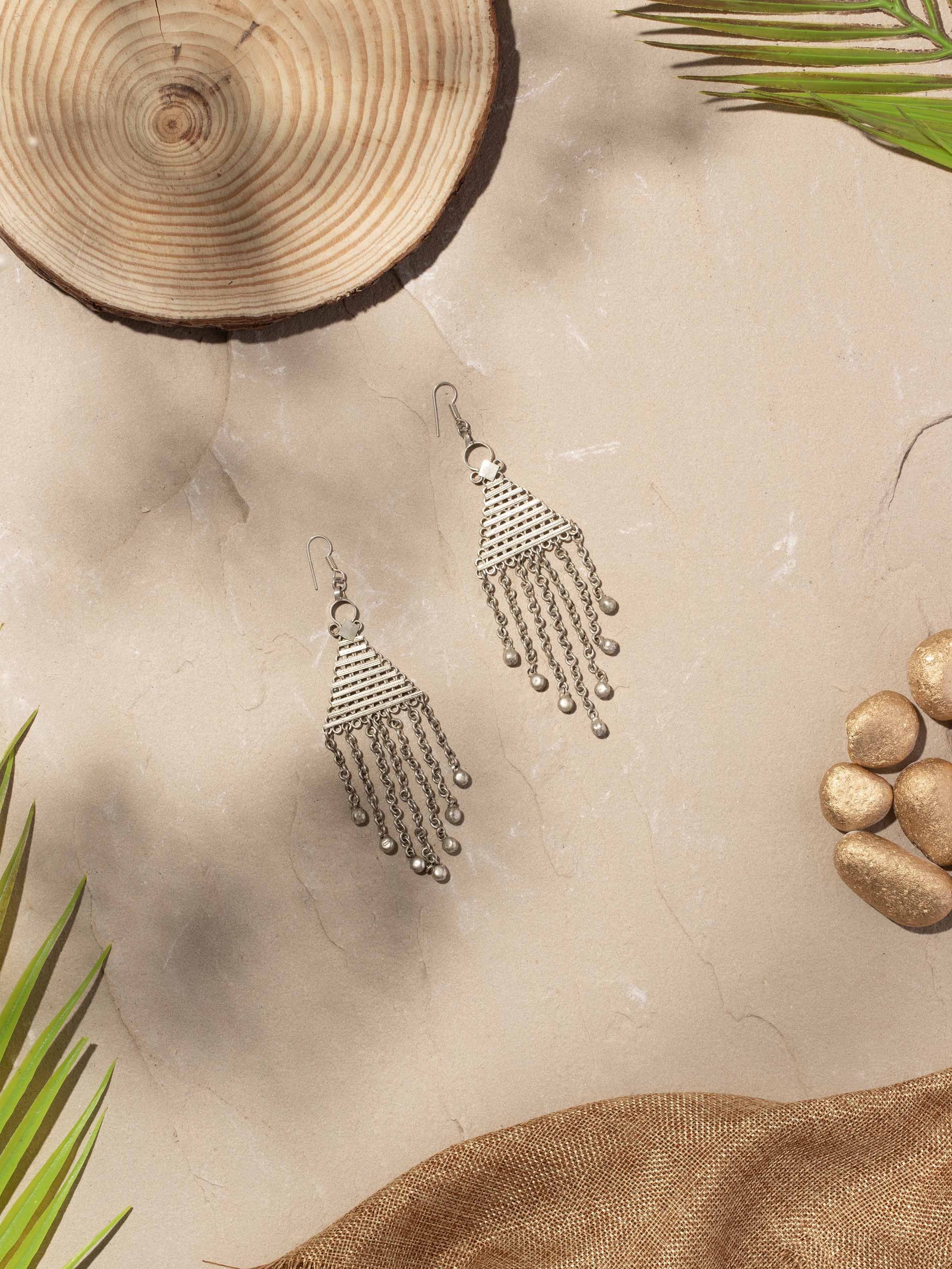 Close-up of Lambani earrings showcasing detailed metalwork and traditional artistry.