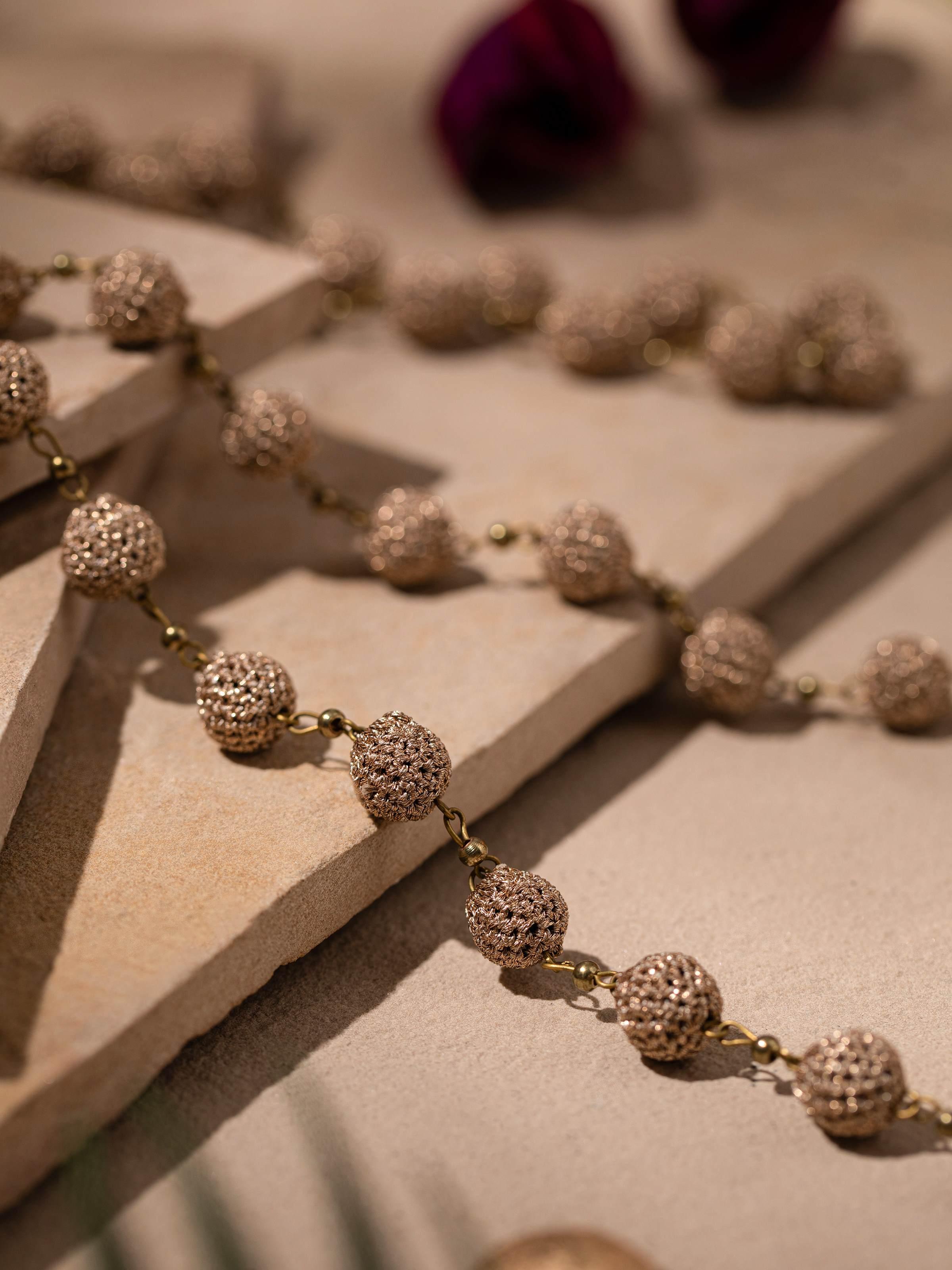 Detailed view of crochet long necklace highlighting the intricate crochet work and elegant texture.