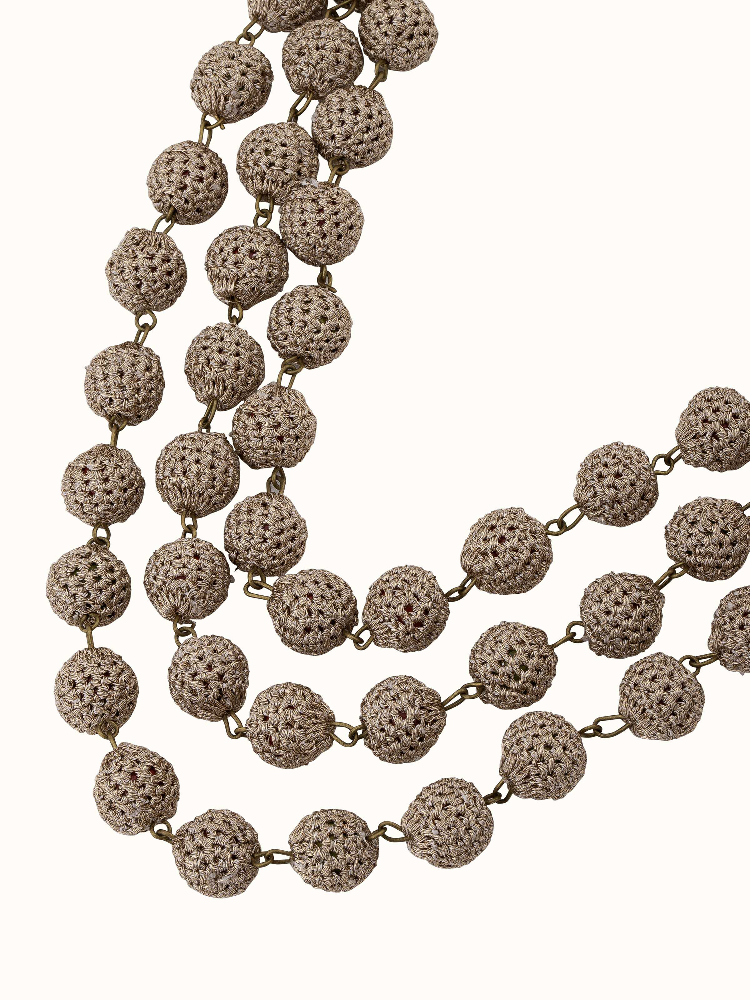 Angled view of Crochet Long Necklace showcasing the intricate crochet and overall design.