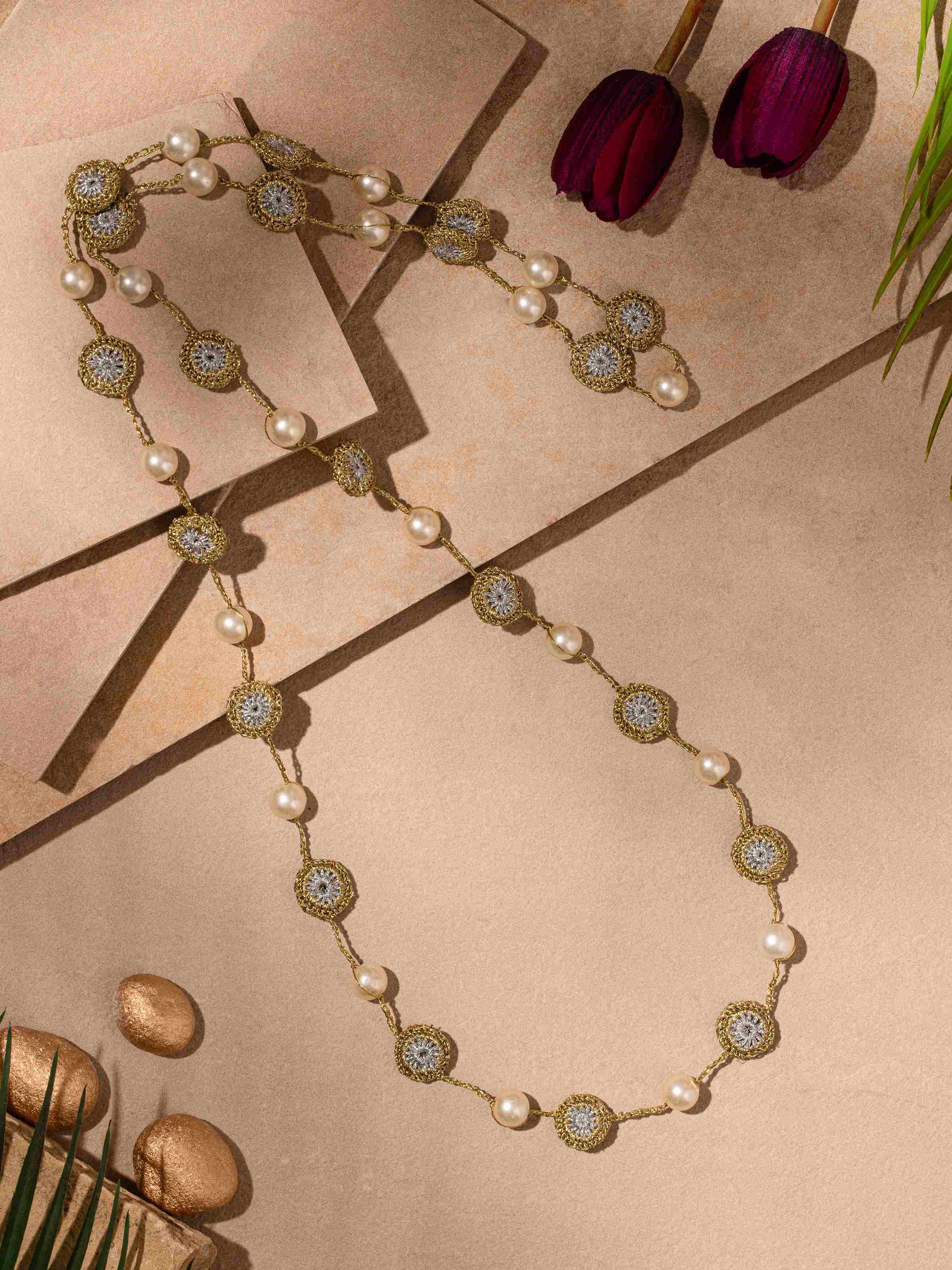 Close-up view of crochet long necklace highlighting the detailed crochet patterns.