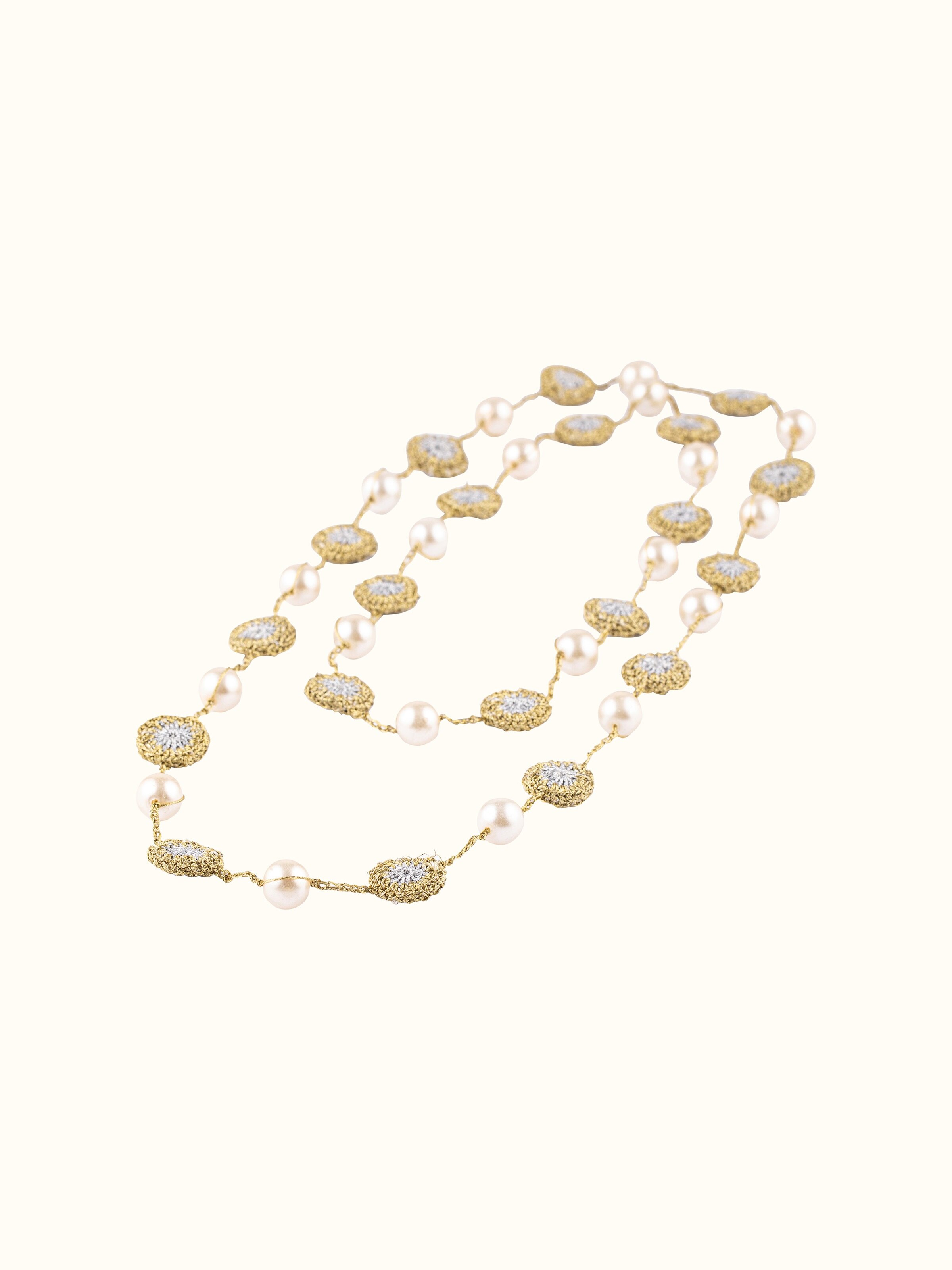 Angled view of crochet long necklace showcasing its unique crochet structure.