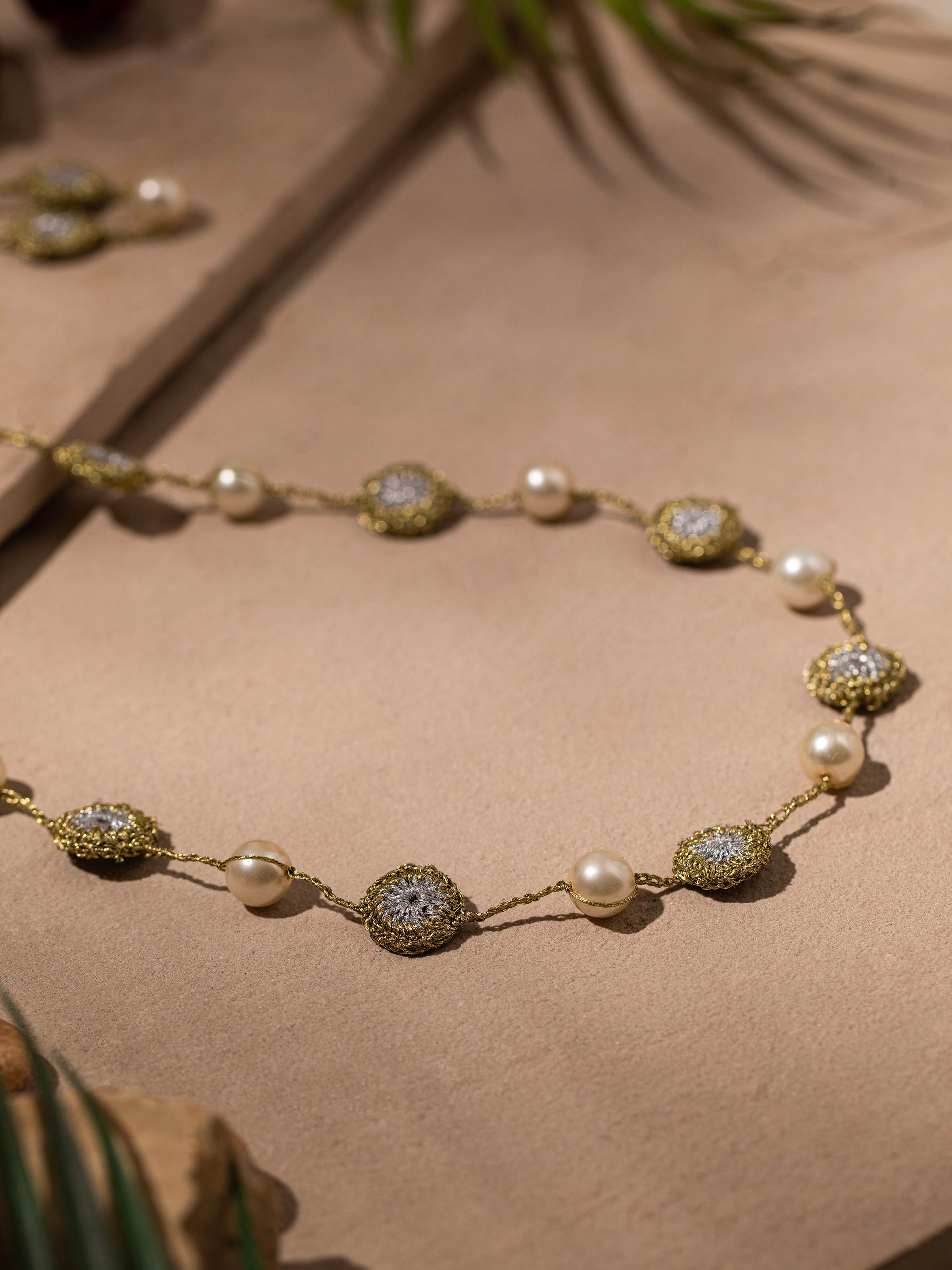 Back view of crochet long necklace highlighting the clasp and crochet work.