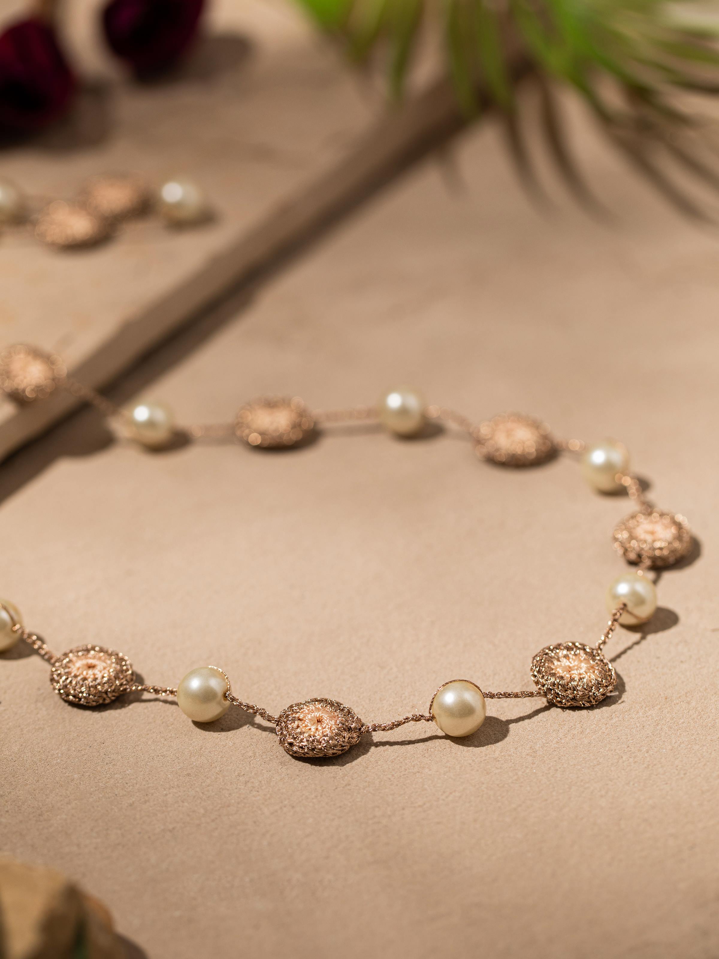 Detailed shot of crochet long necklace focusing on its artisanal crochet details