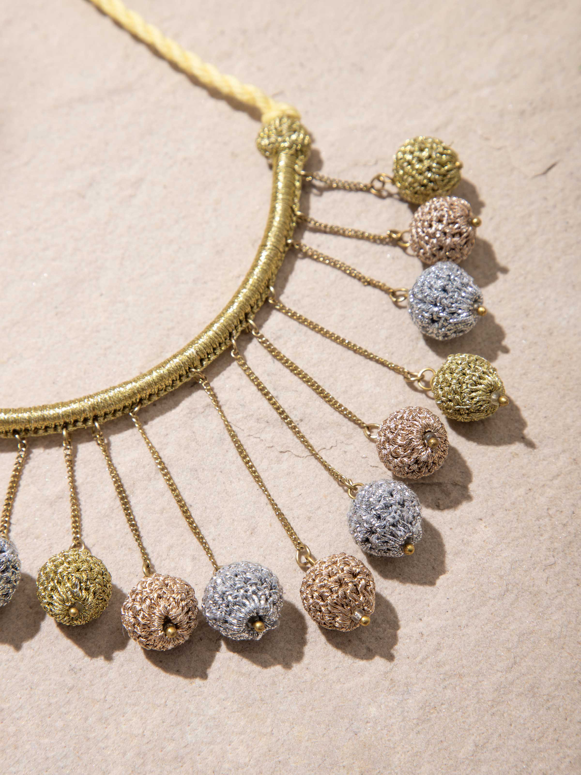 Crochet long necklace displayed in a box, showing its complete presentation and elegant design.