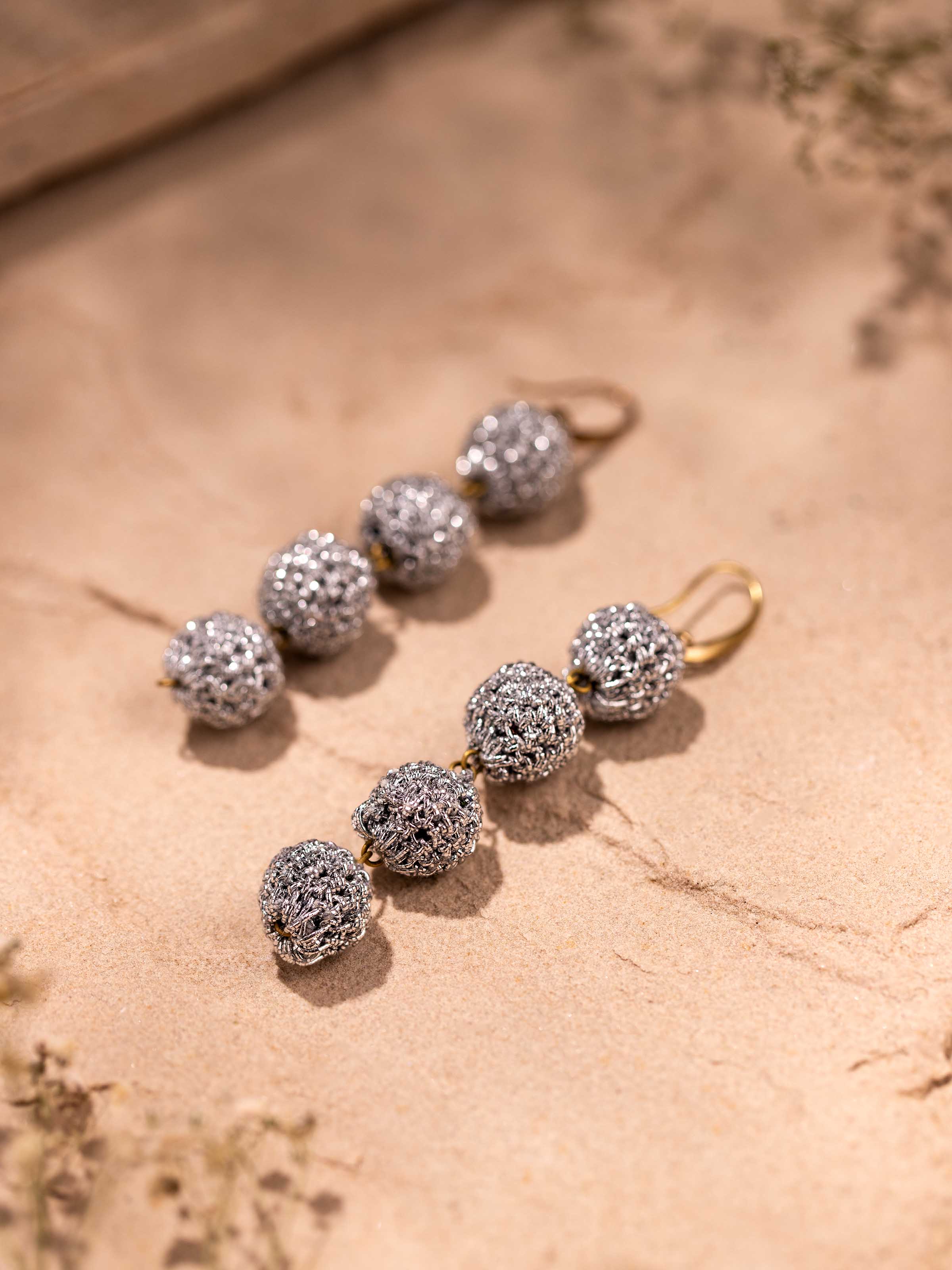 Detailed view of Crochet Drop Earrings highlighting the intricate crochet work and design elements.