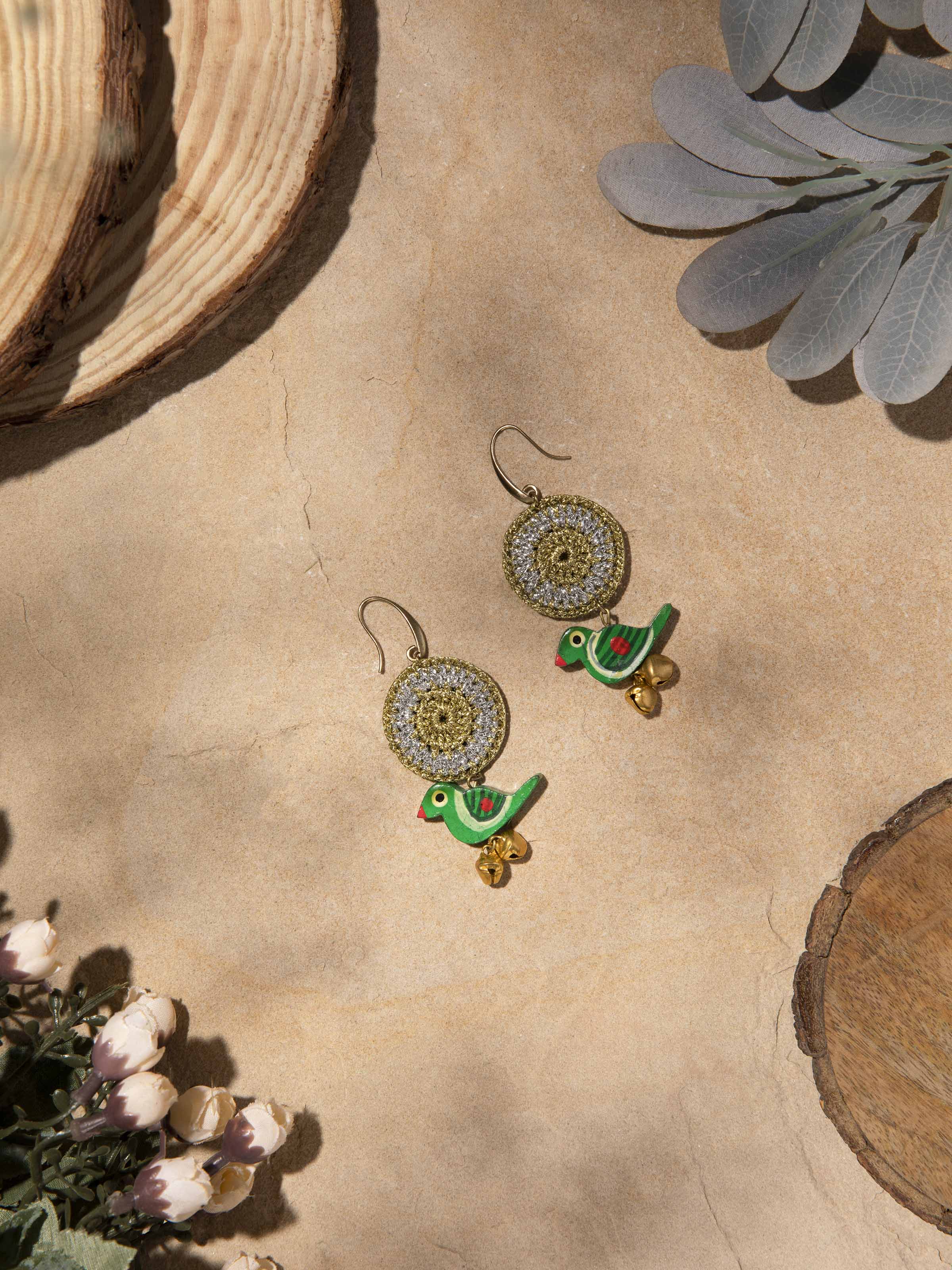 Close-up of crochet drop earrings emphasizing fine crochet work and design