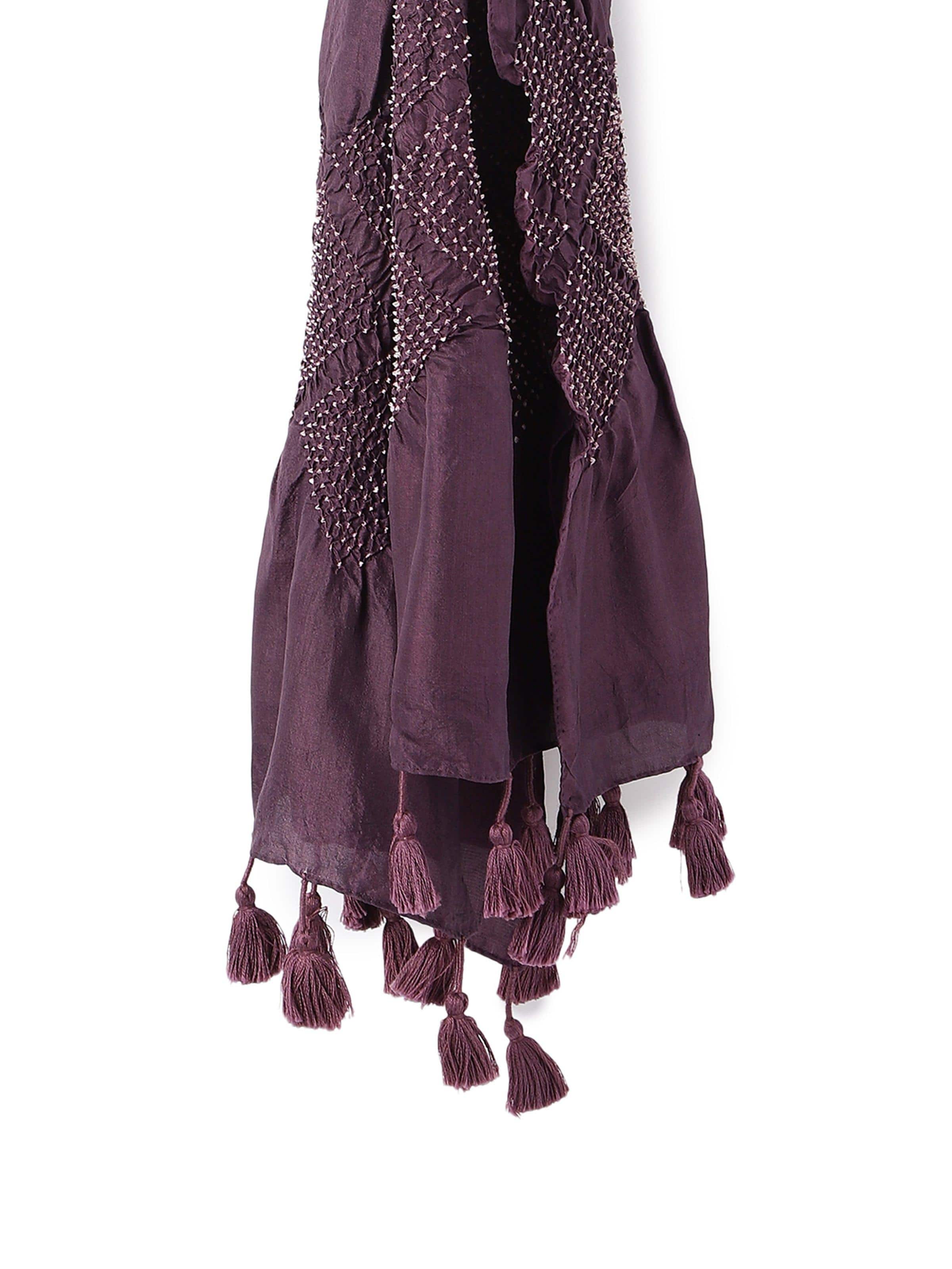 Detail shot of Bandhani tie-dye patterns on purple silk stole showcasing fine dot motifs