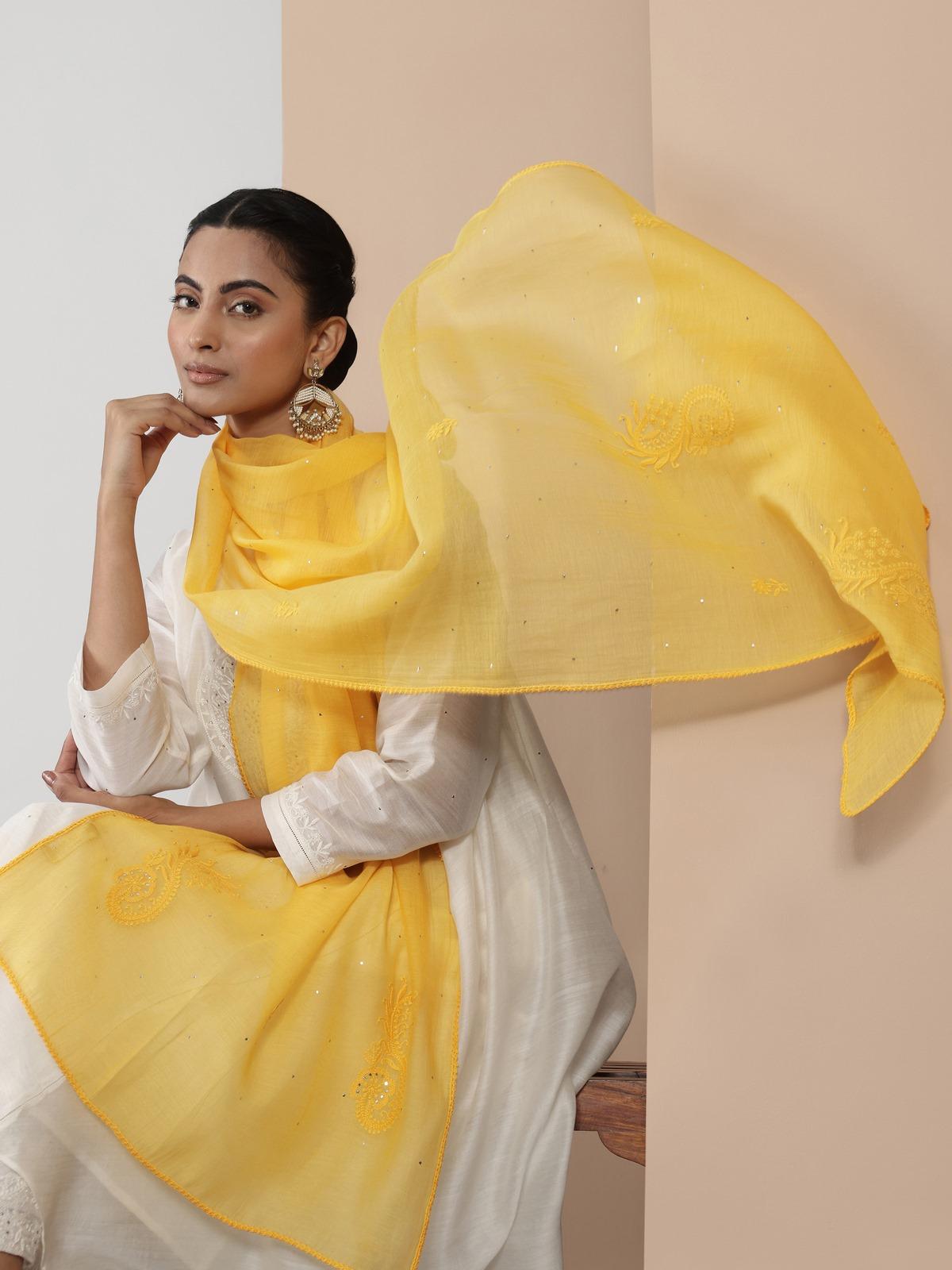 Lifestyle shot of yellow cotton silk chikankari stole styled to highlight intricate hand embroidery.