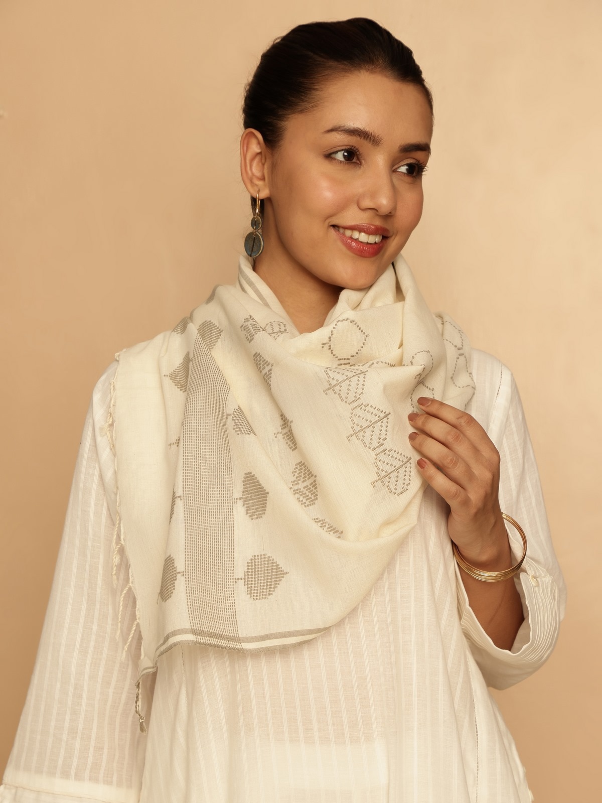 Lifestyle view of extra-weft cotton stole draped elegantly over shoulders.