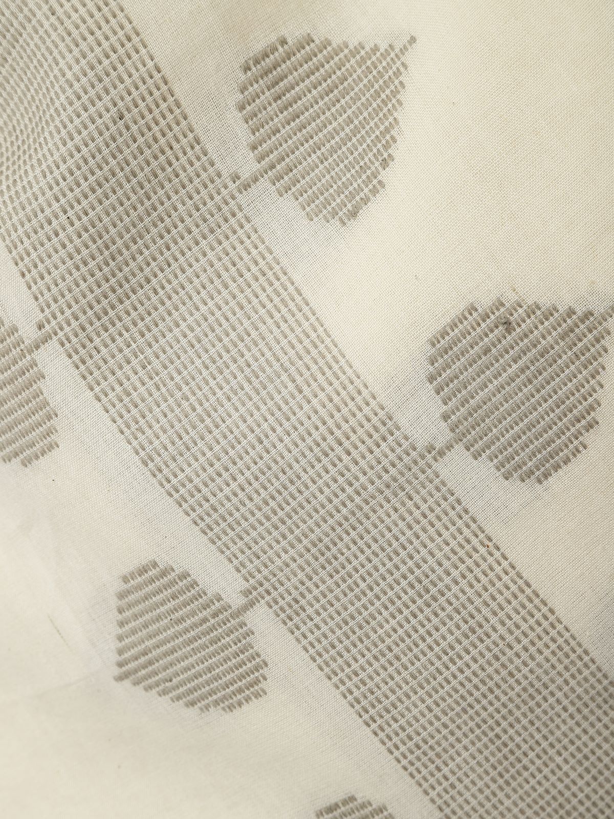 Detail view of off-white cotton stole showing fine extra-weft texture and softness.