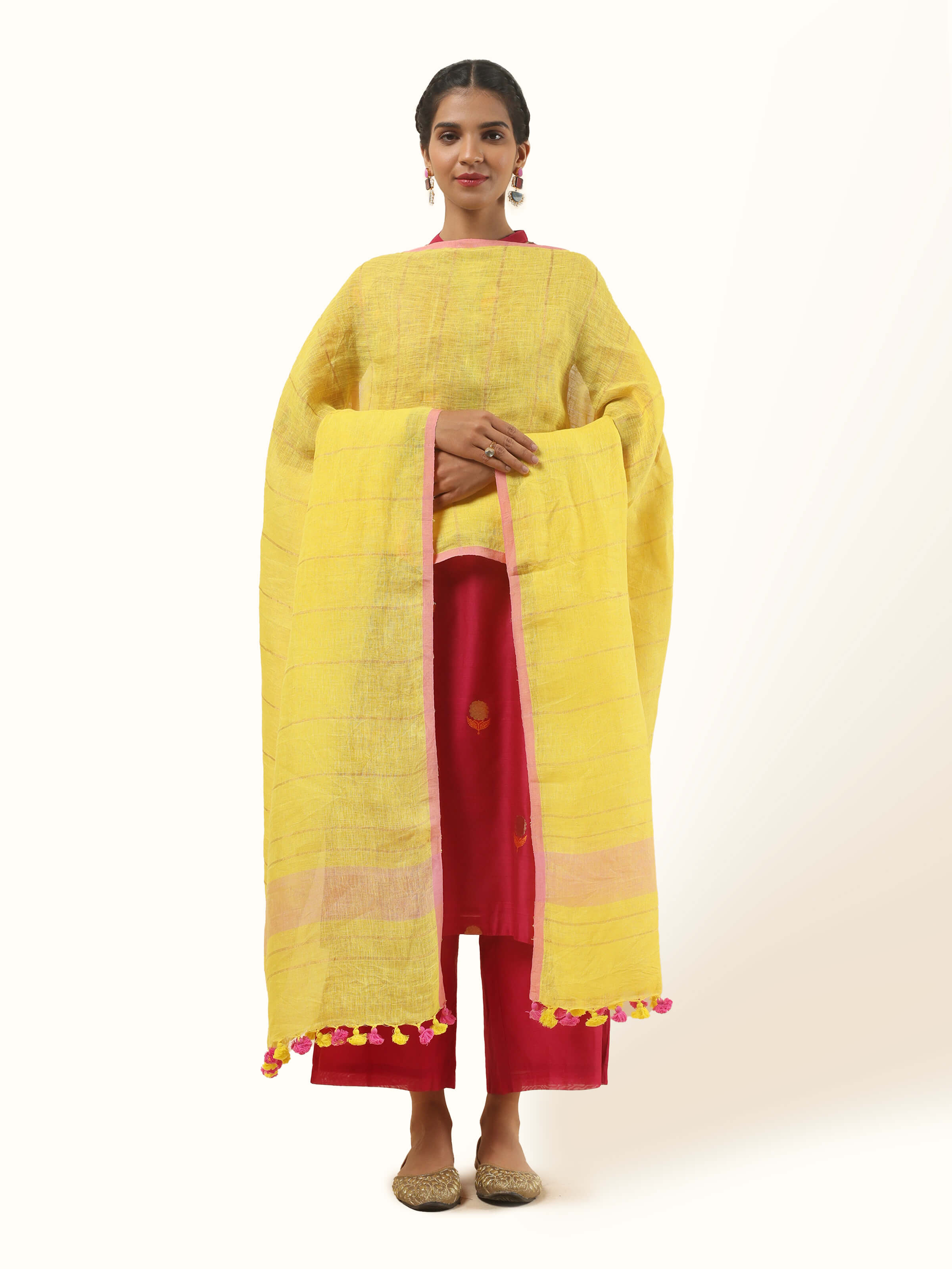 Front view of yellow linen dupatta featuring hand-tied tassels and breezy woven texture