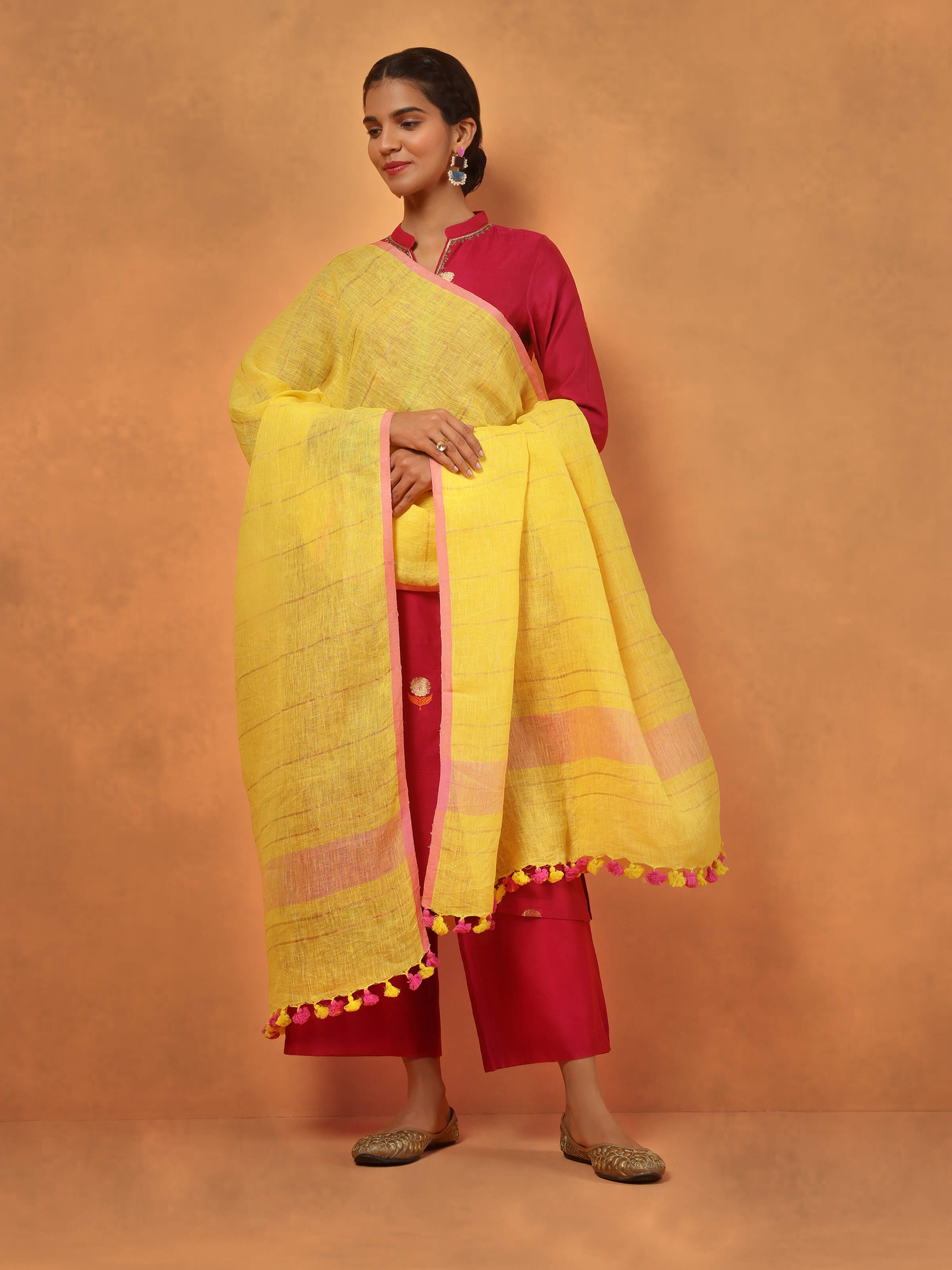 Lifestyle view of yellow linen tassel dupatta paired with ethnic outfit for a vibrant look