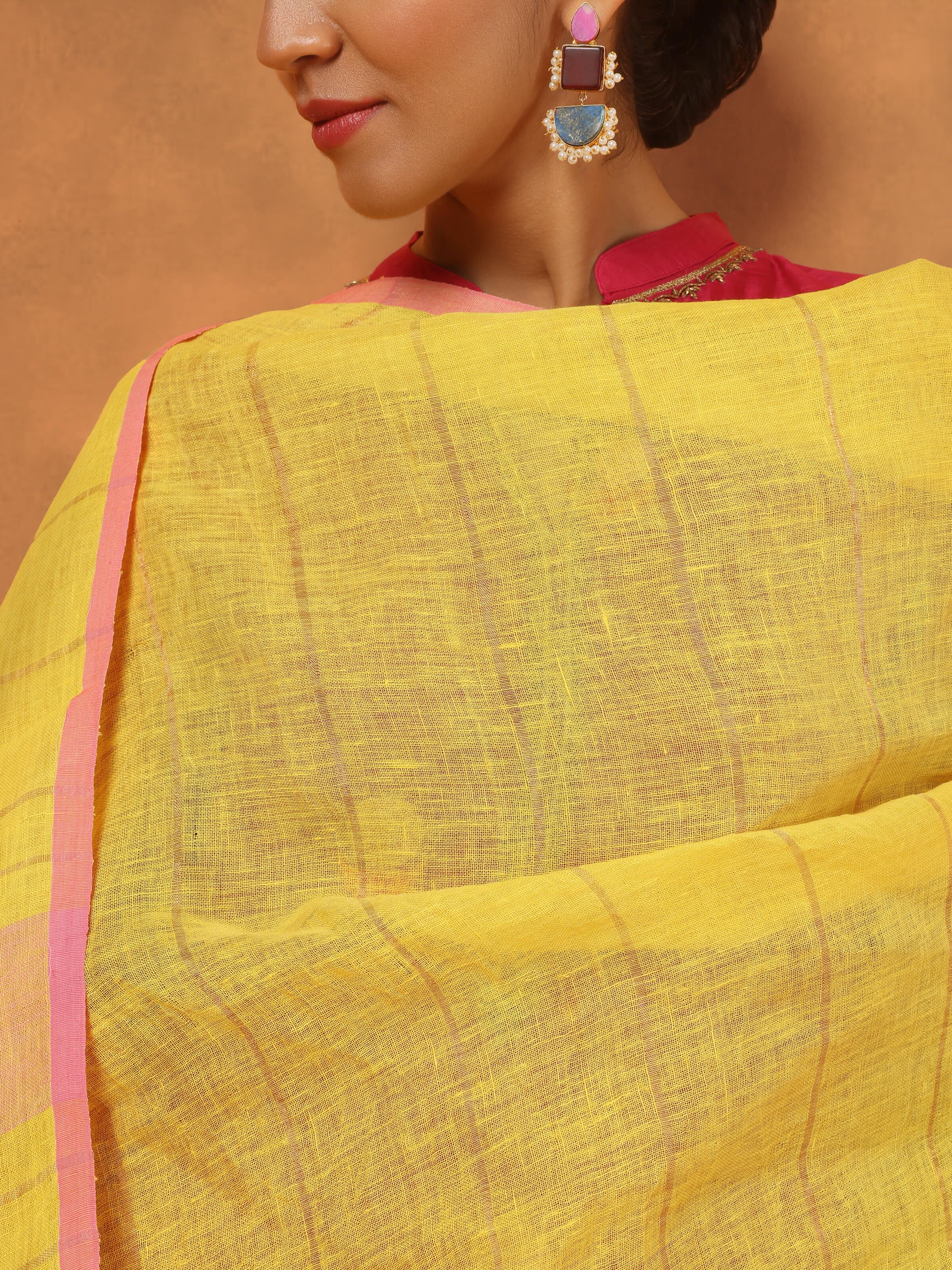 Angled view showing natural texture and soft drape of bright yellow linen dupatta