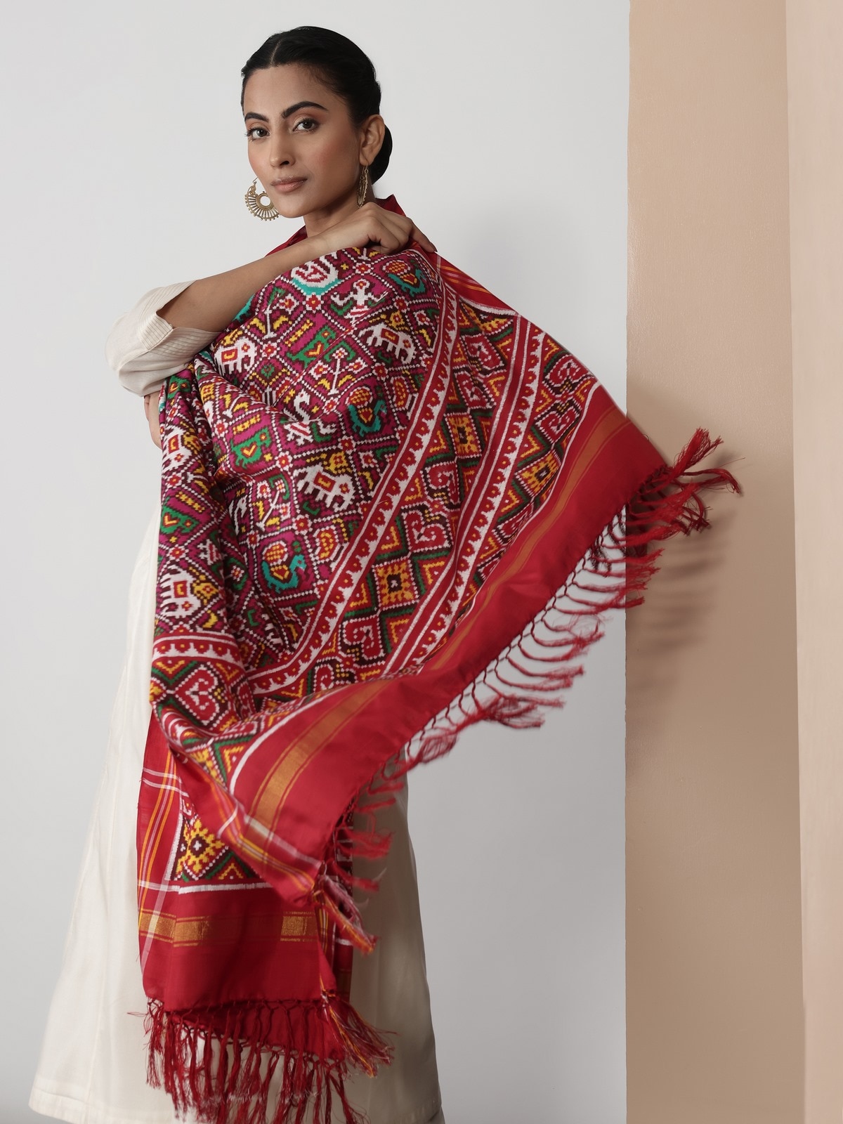 Close-up lifestyle view showing intricate Patola weave and vibrant pink color