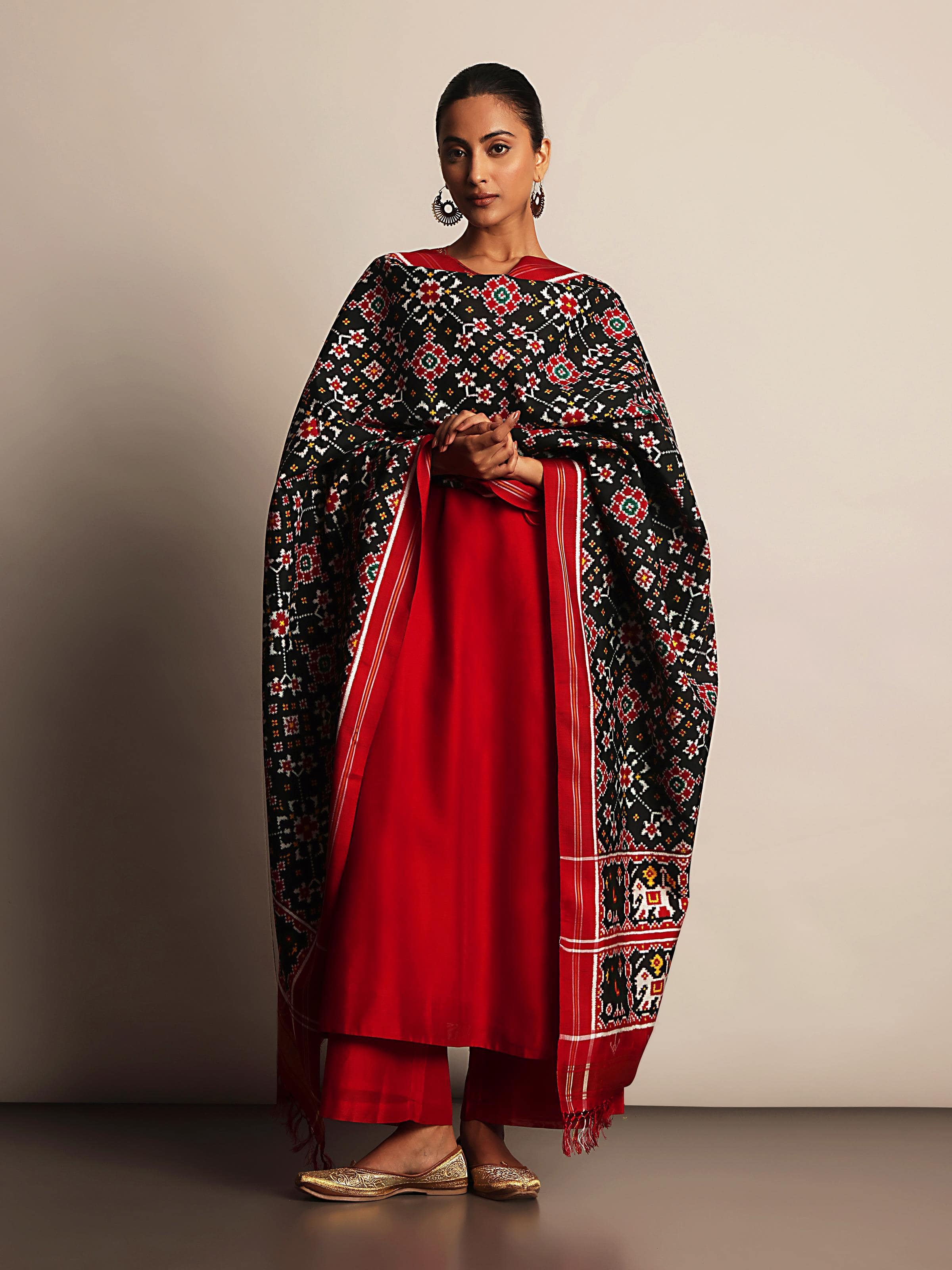 Lifestyle shot of Black Silk Patola Dupatta draped elegantly over shoulder.