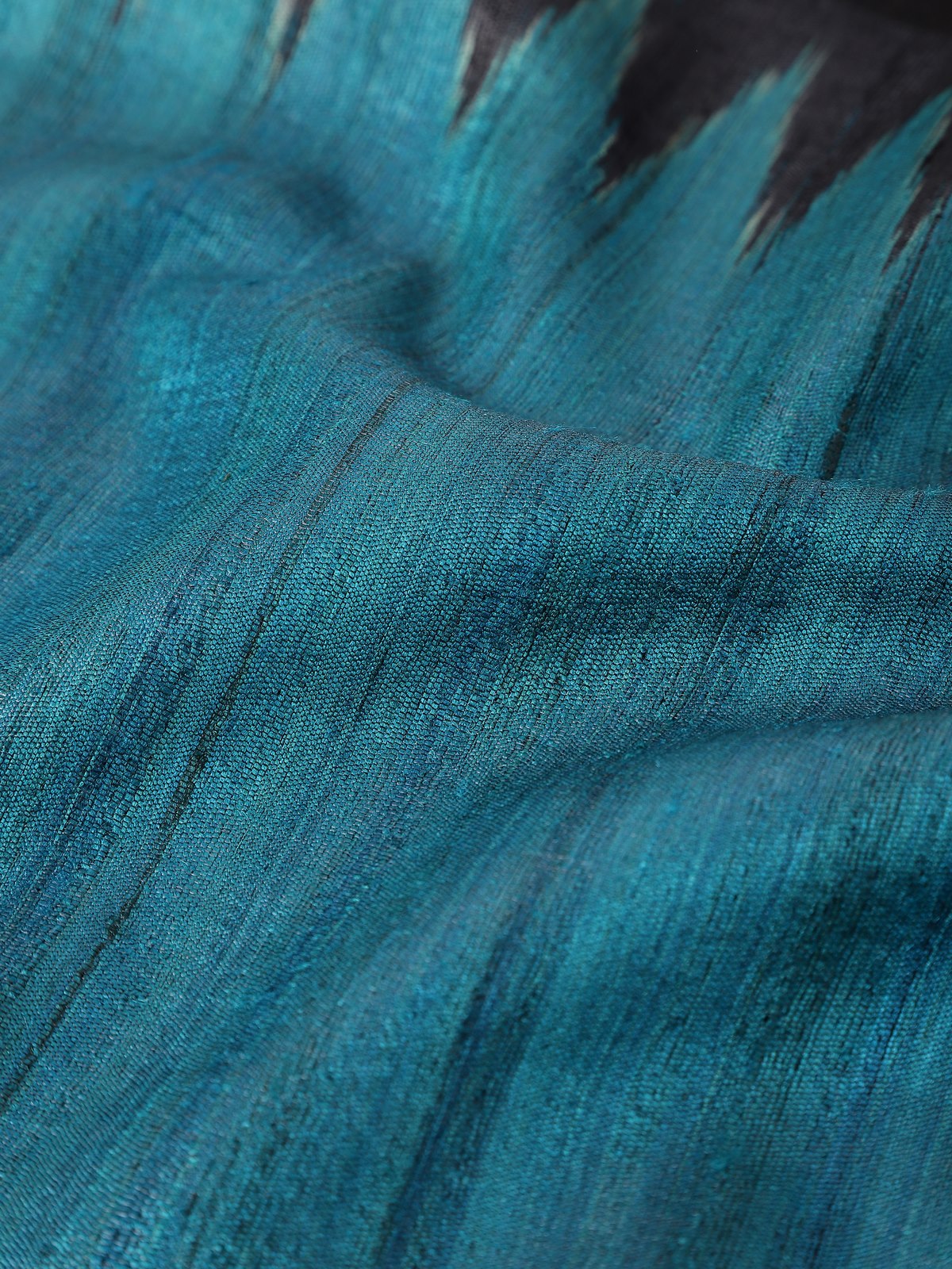 Detailed view capturing the fine weave and elegant sheen of the Tussar silk