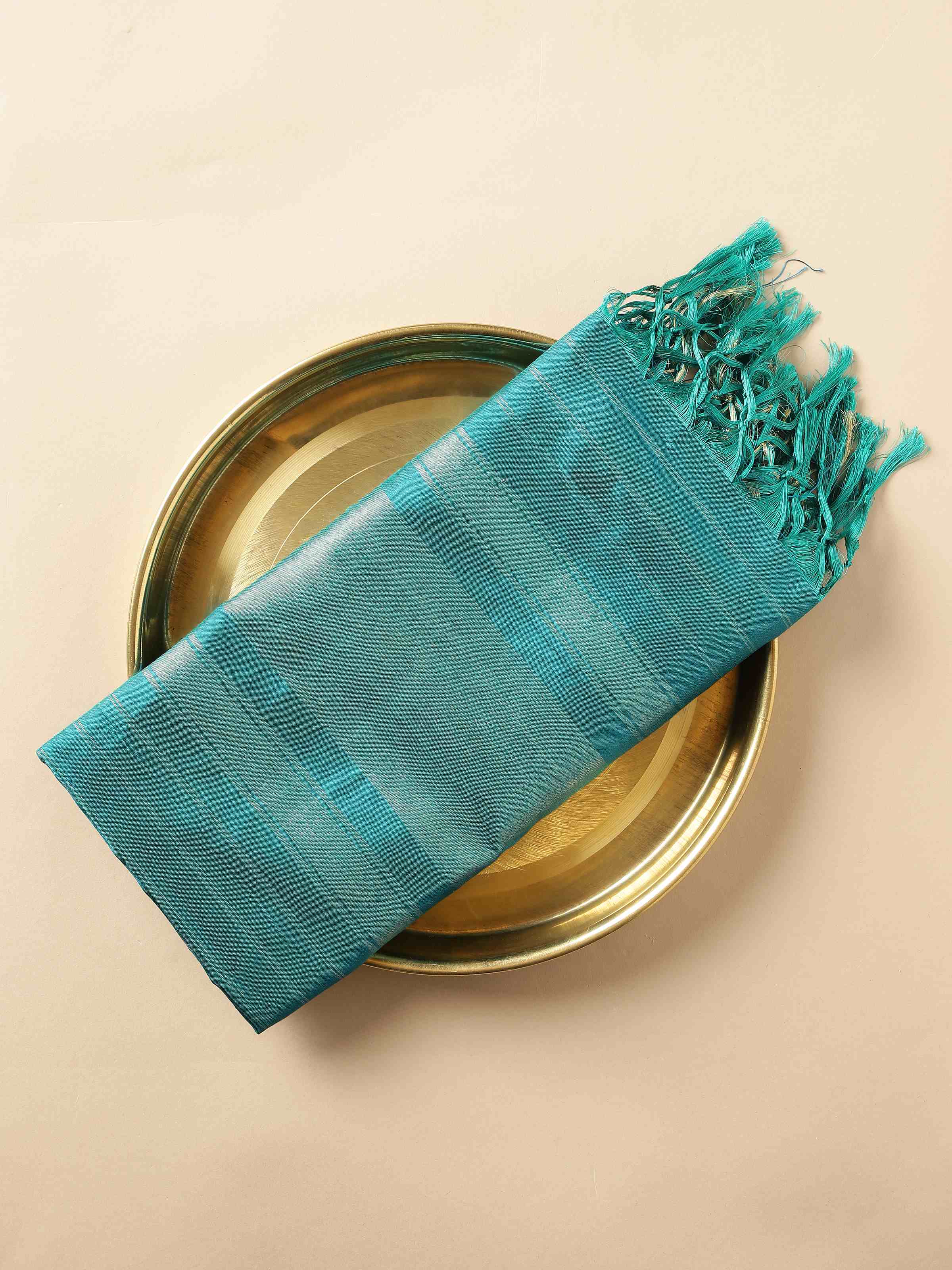 Close-up view showing gold zari detailing and Ikat weave on blue silk dupatta