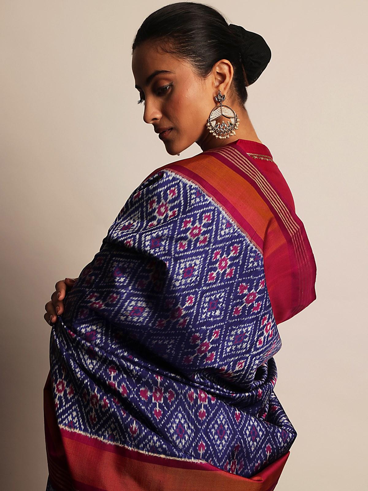 Detailed view of the blue and pink silk Ikat dupatta fabric showing rich zari borders and traditional design.