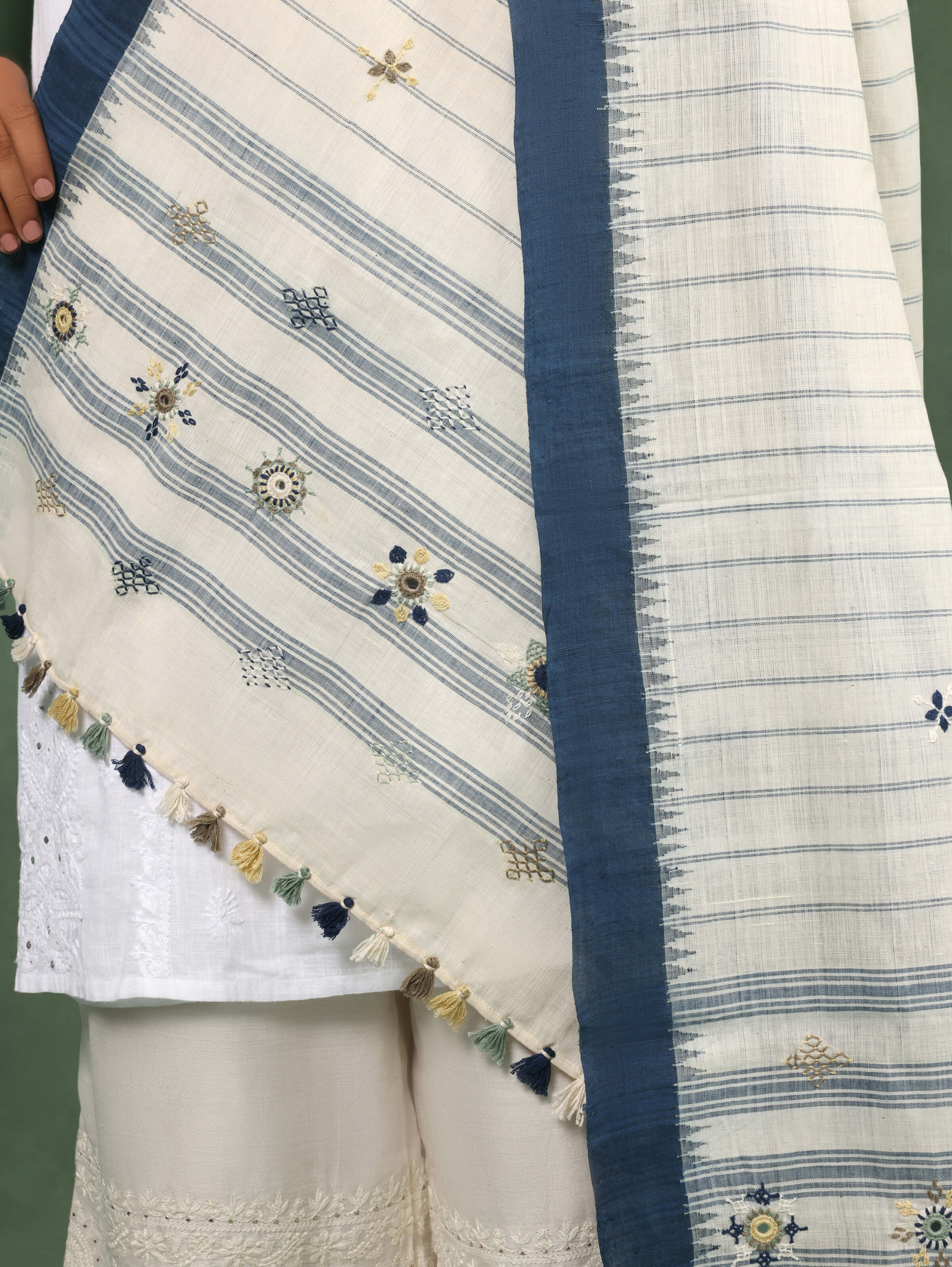 Close-up detail of Lambani embroidery on blue cotton dupatta emphasizing intricate stitching.
