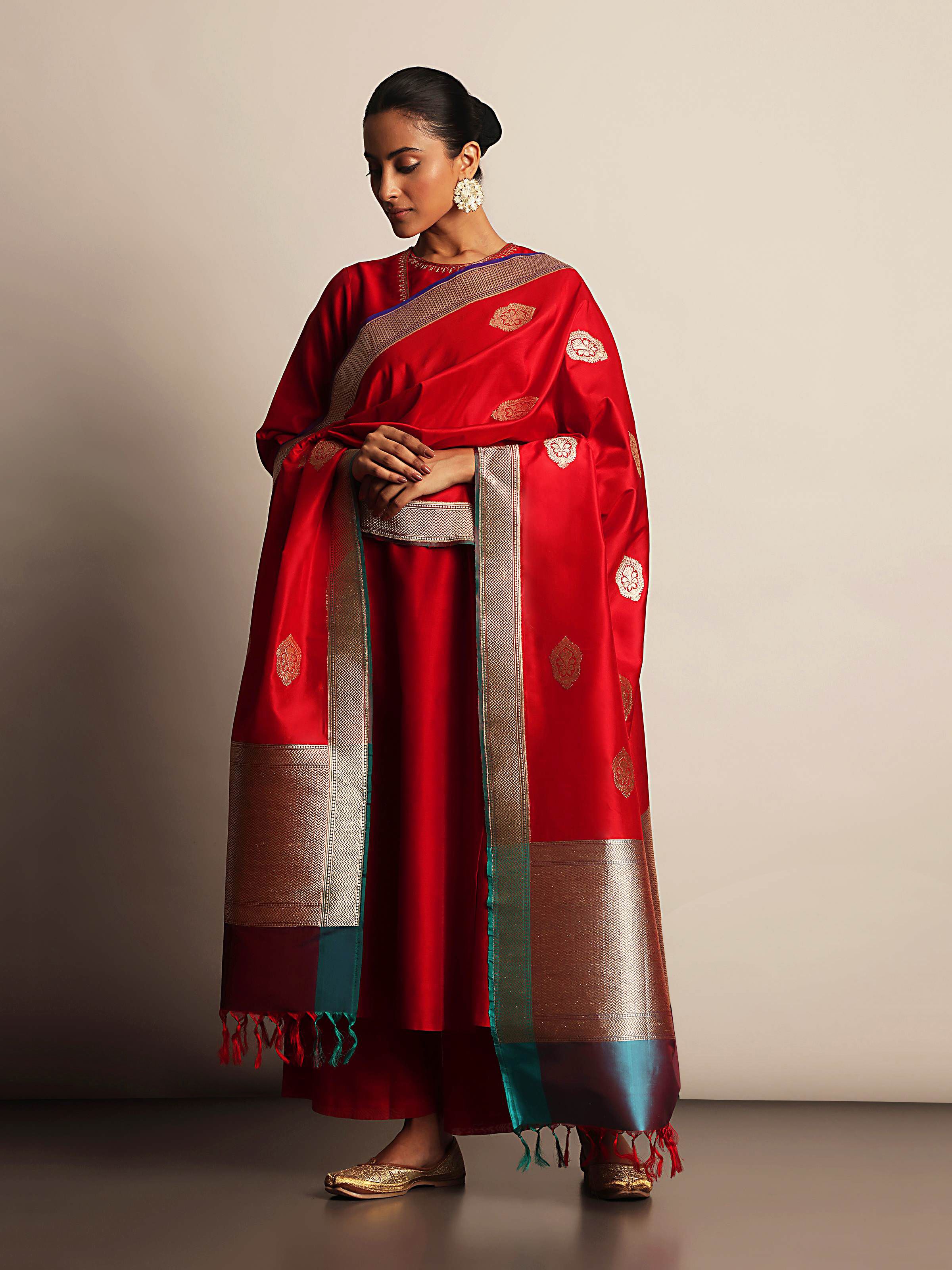 Lifestyle view of red and gold Banarasi silk dupatta draped over shoulder