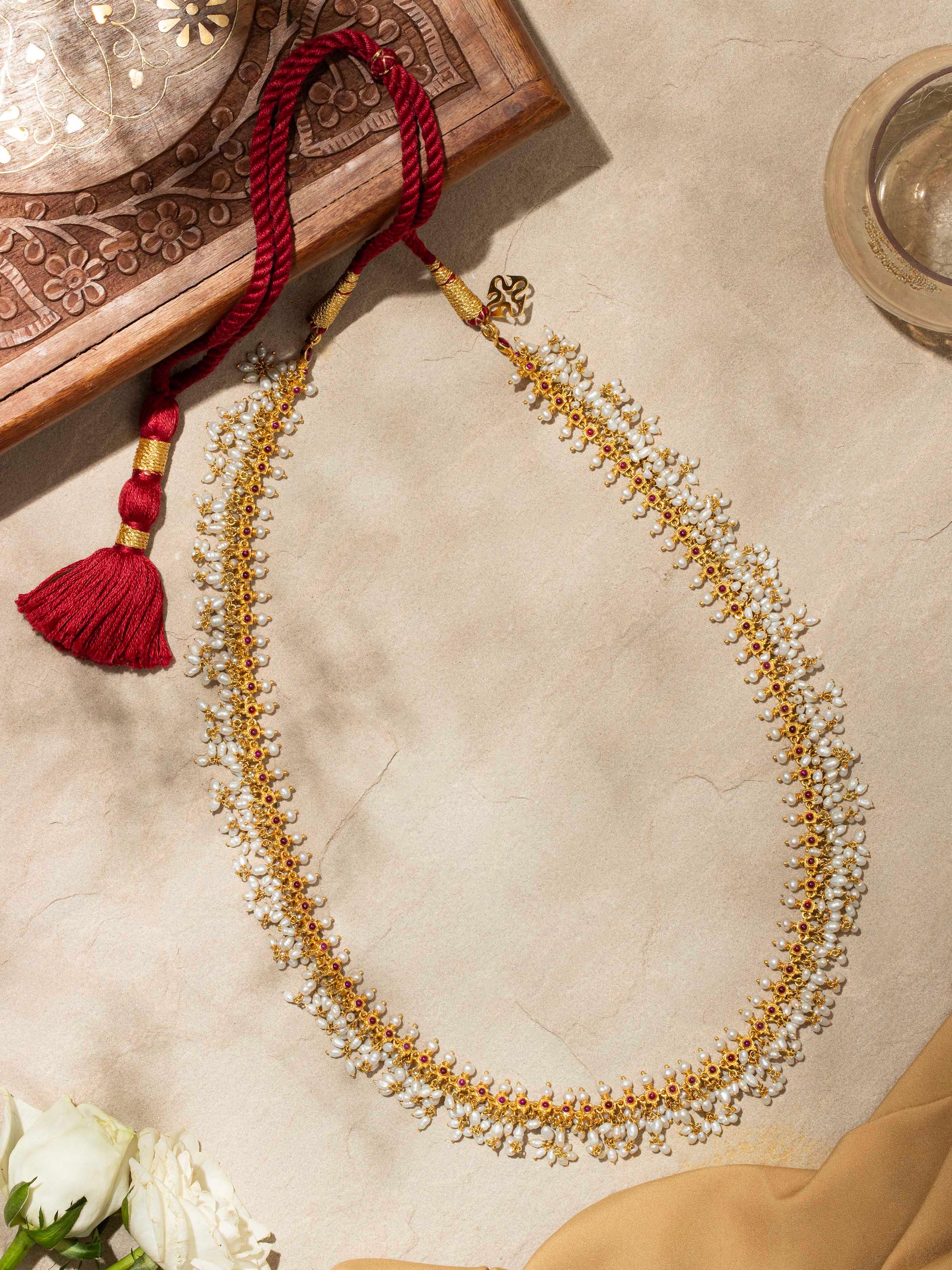 Side view of Guttapusalu Silver Long Necklace showcasing the intricate silver details and design.
