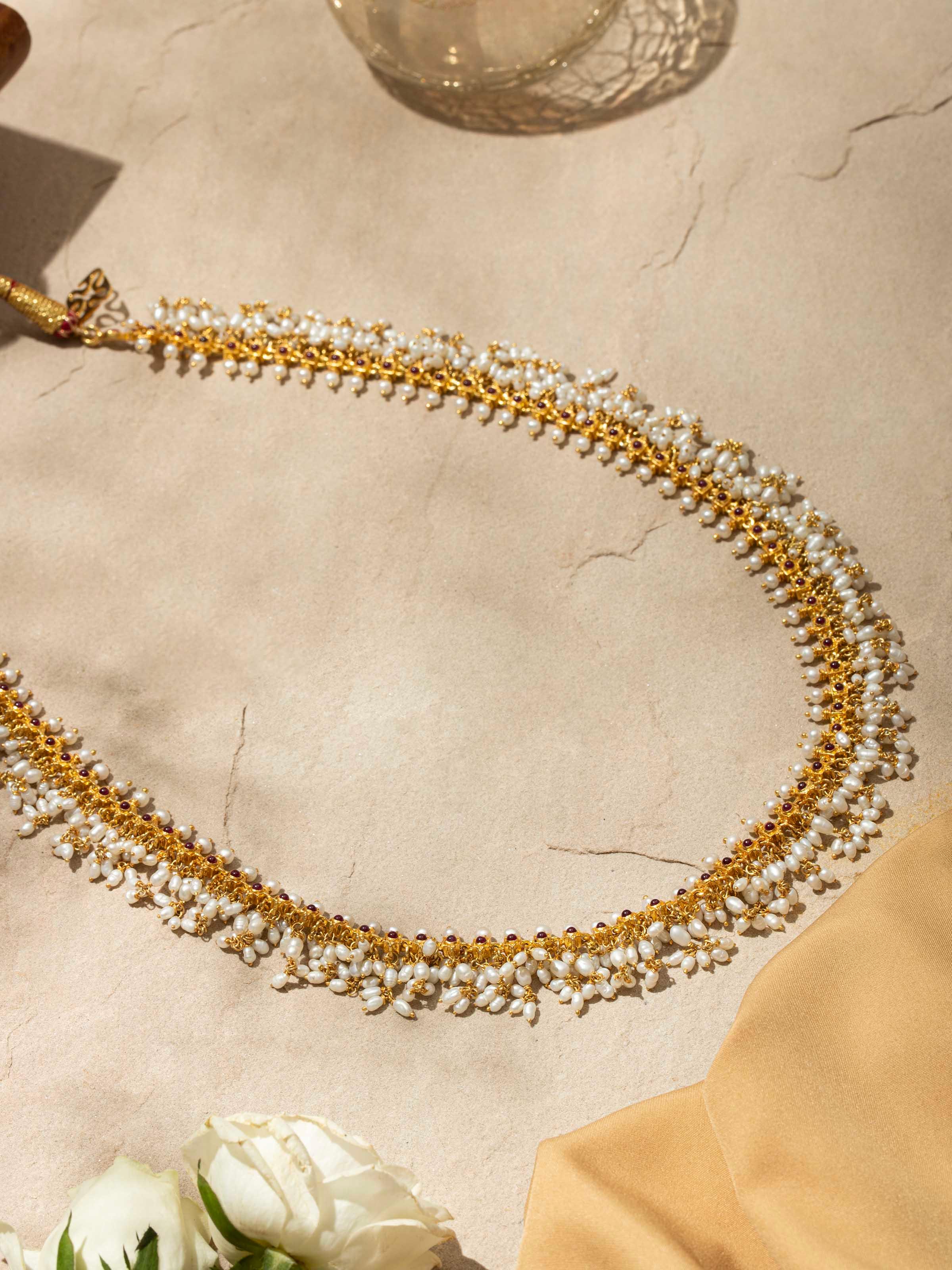 Angled view of Guttapusalu Silver Long Necklace highlighting the traditional craftsmanship and design.