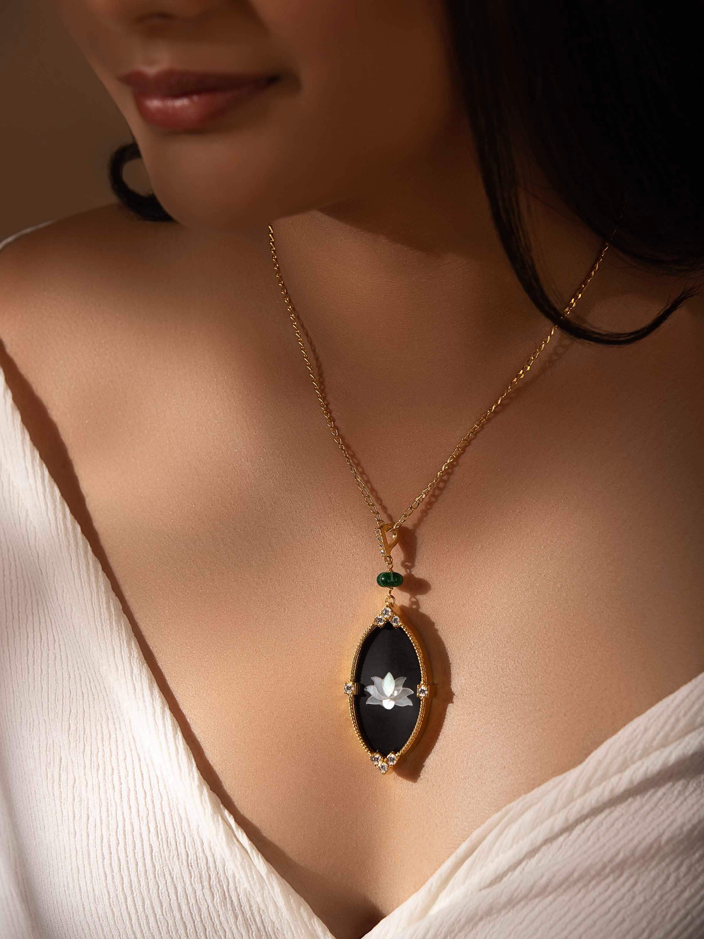 Lifestyle shot featuring silver pendant worn over a pastel ethnic outfit