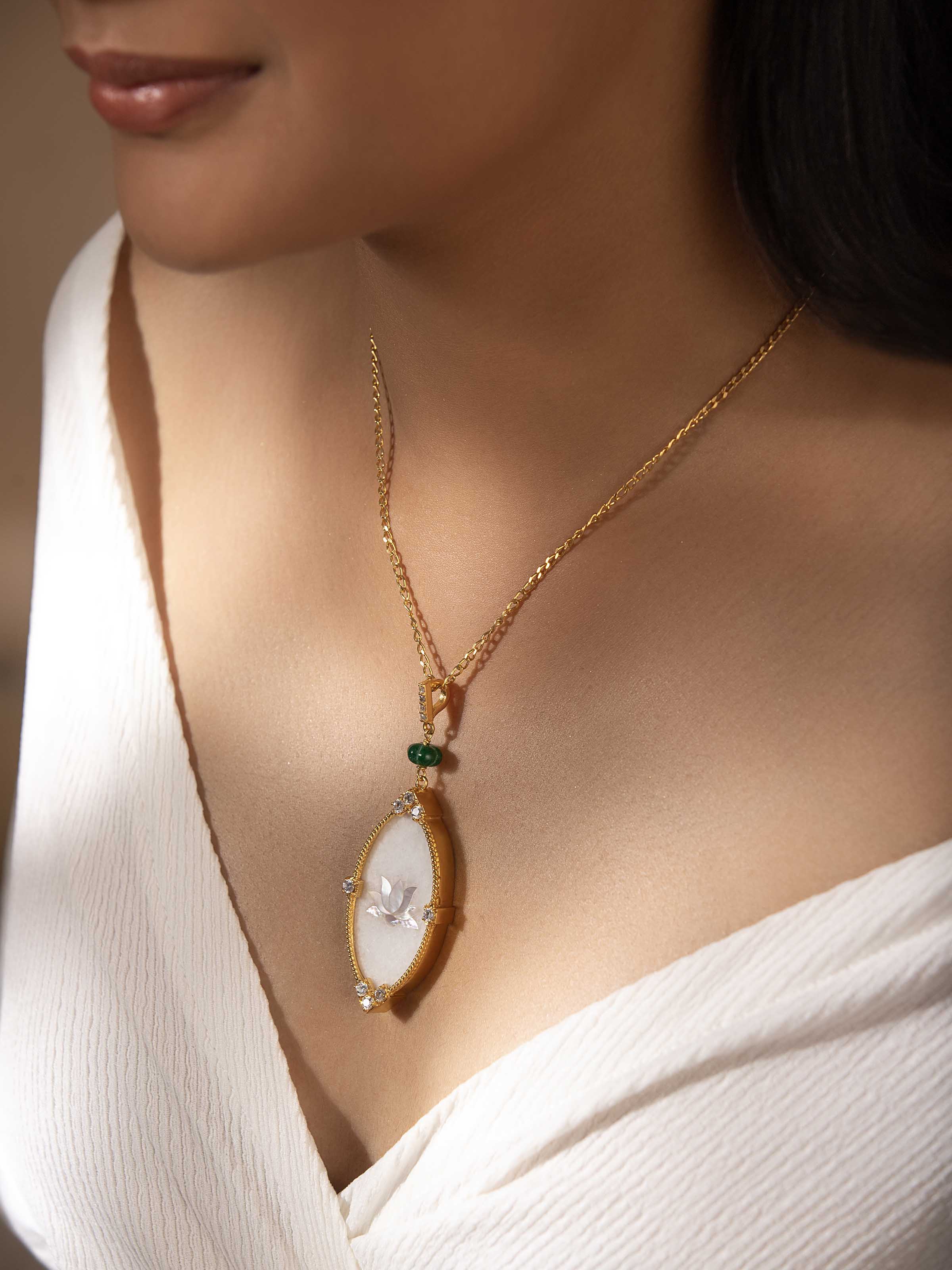 Side angle showcasing the pendant's fine craftsmanship and polished chain